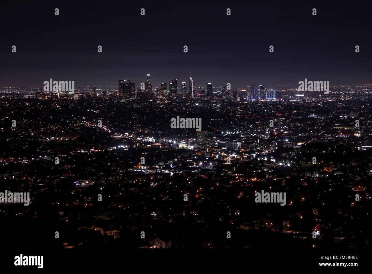 Aerial view of illuminated modern cityscape with sky in background at ...