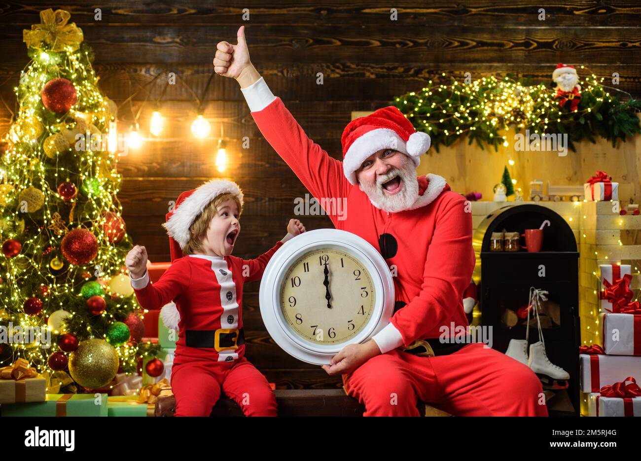 https://c8.alamy.com/comp/2M5RJ4G/santa-claus-and-little-child-boy-with-clock-time-to-celebrate-new-year-midnight-winter-holidays-2M5RJ4G.jpg