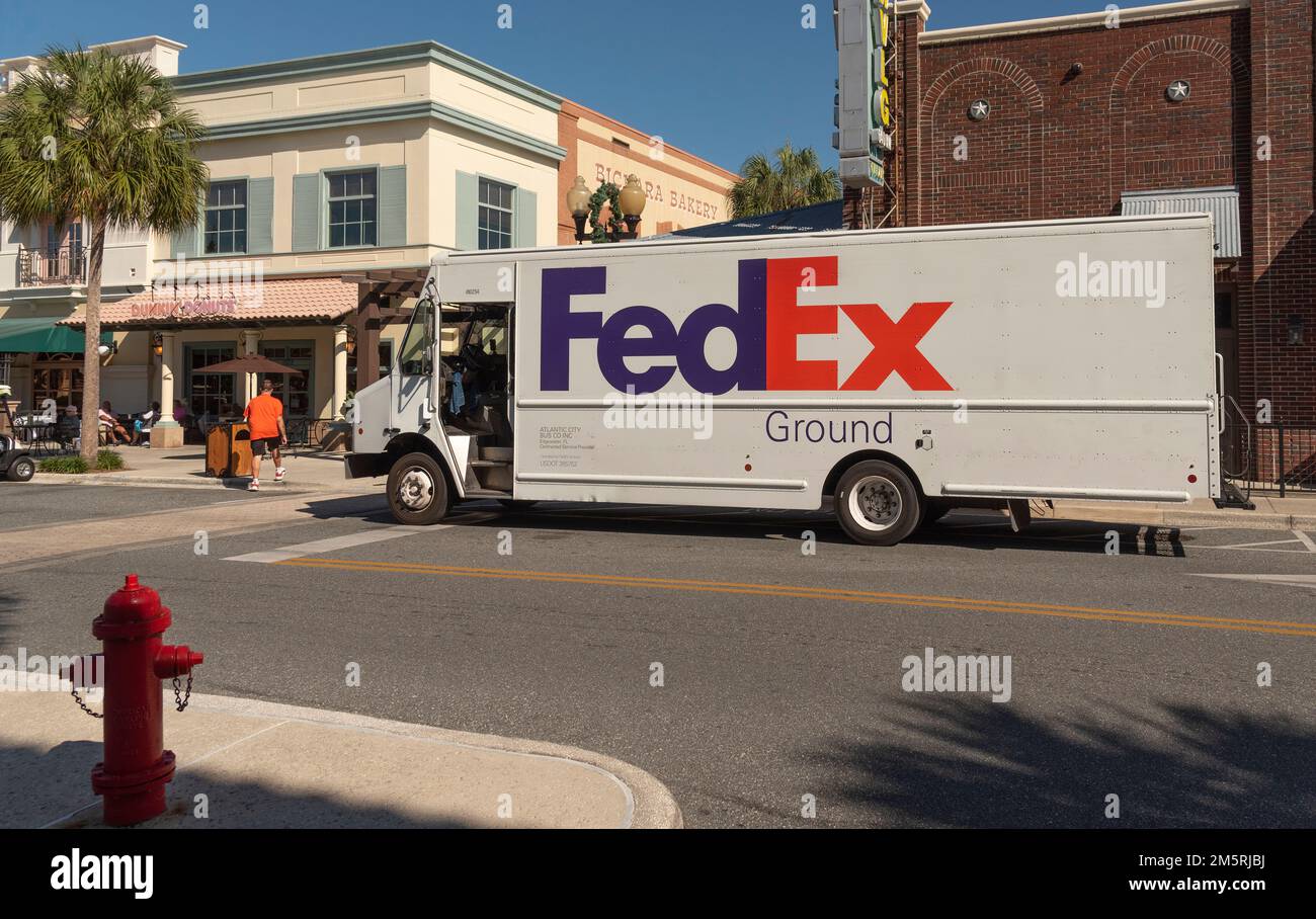 The Villages, Florida, USA. 2022.  International packet and parcel carrier delivery truck making a stop in a Florida town center. Stock Photo