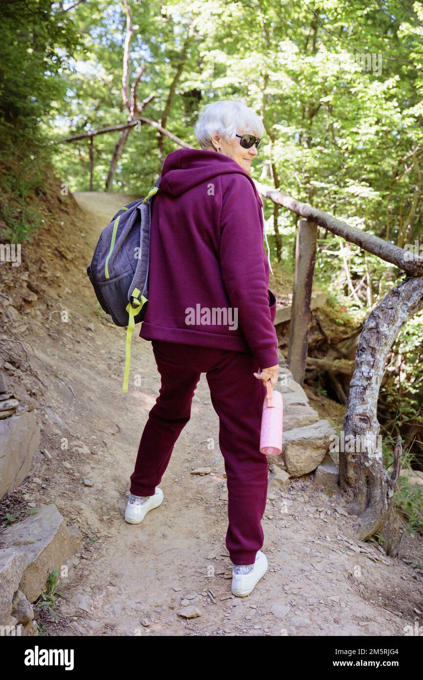 Smiling senior woman backpack hi-res stock photography and images - Alamy