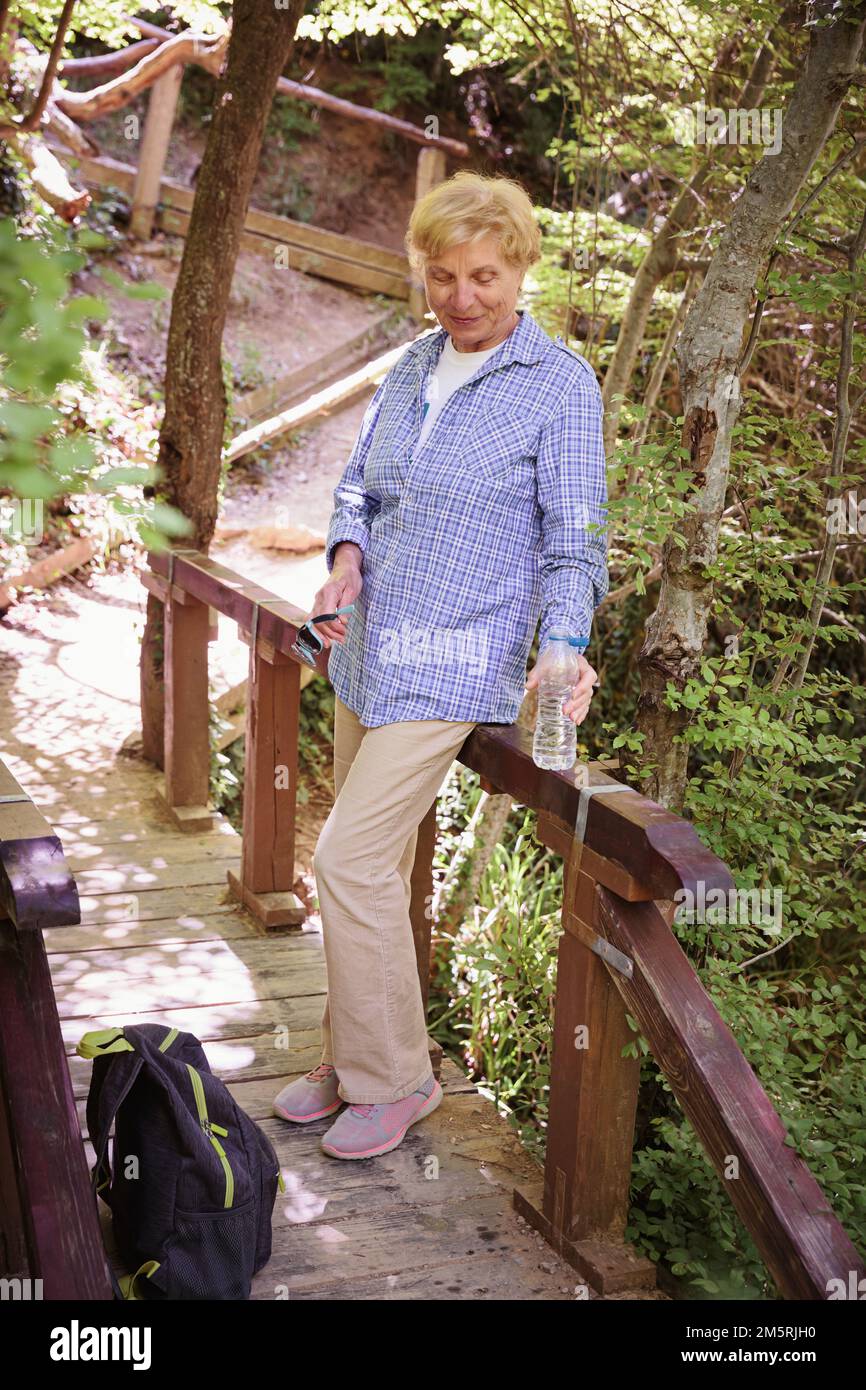 Senior woman hiking forest trail hi-res stock photography and images ...