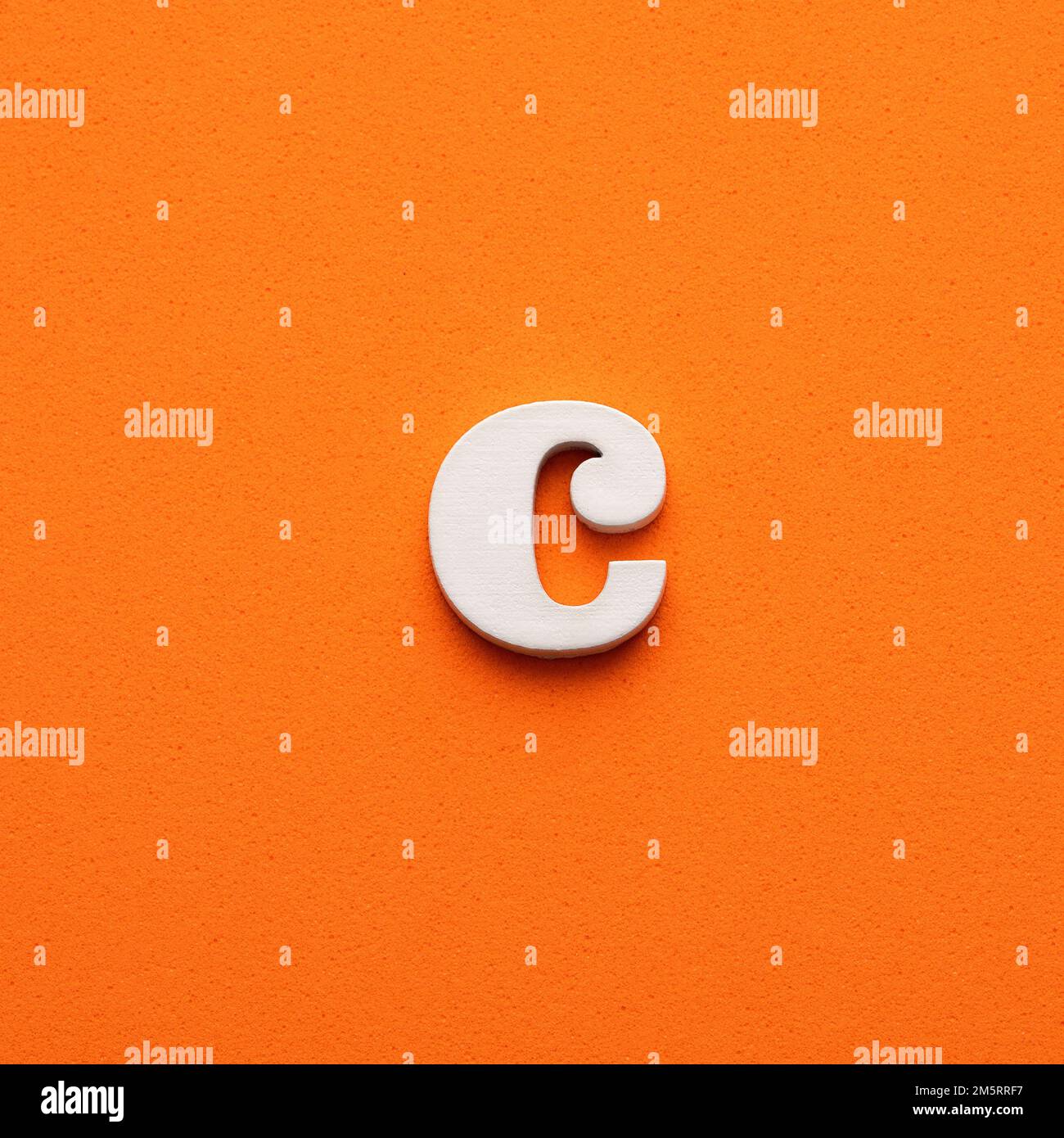 White lowercase letter c on orange foamy background Stock Photo - Alamy
