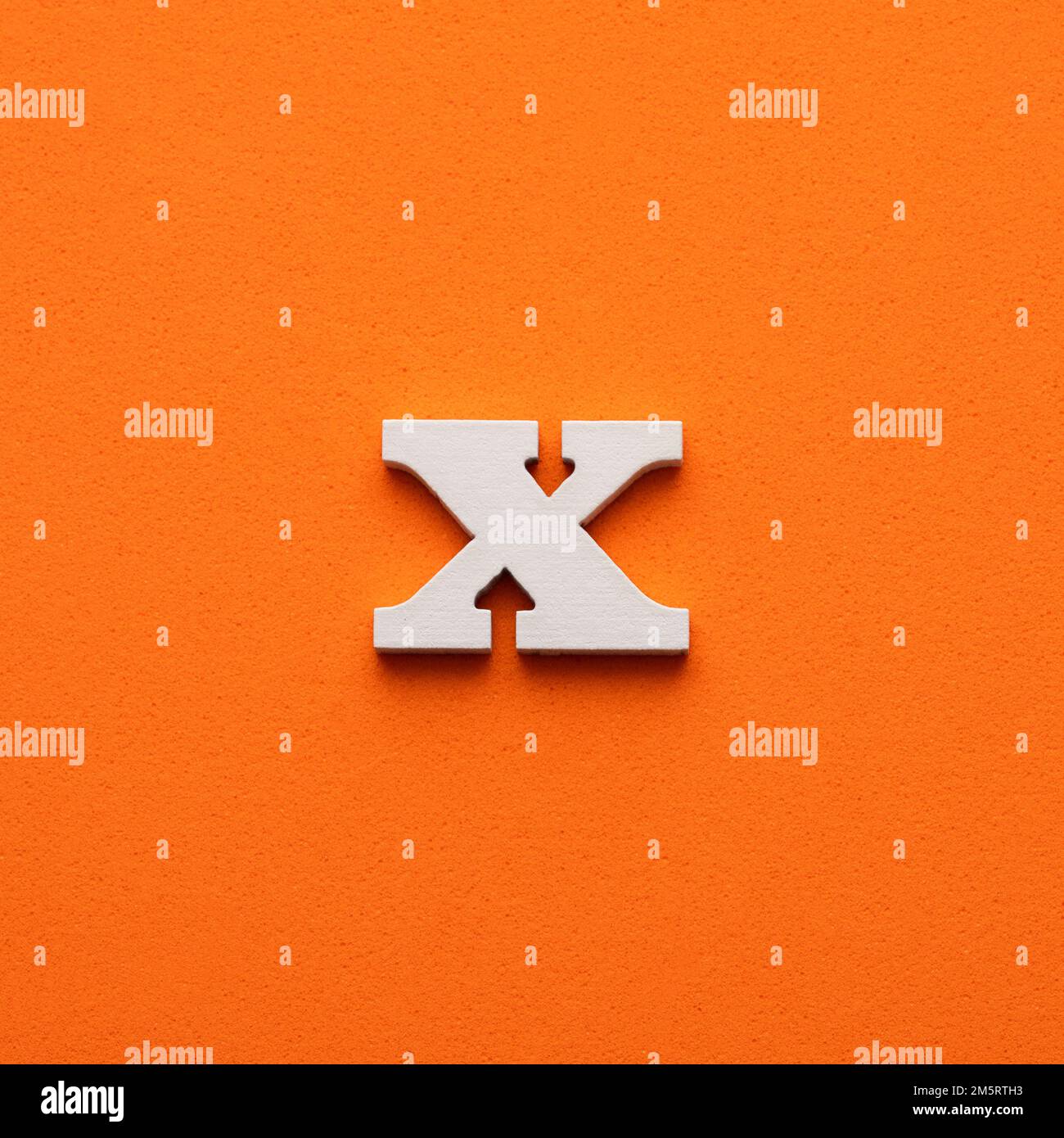 White lowercase letter x on orange foamy background Stock Photo Alamy