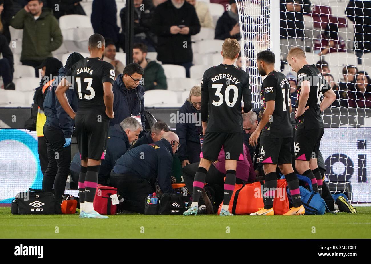 Brentford's Ivan Toney receives treatment after picking up an injury ...