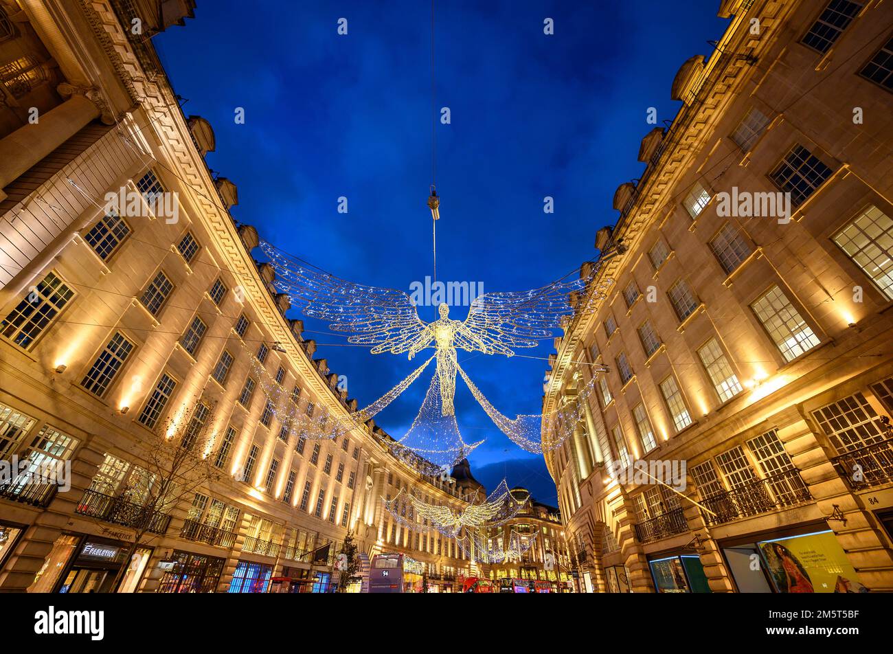 Architecture along Regent Street in London, UK. Evening view of Regent Street with Christmas lights above the road Stock Photo