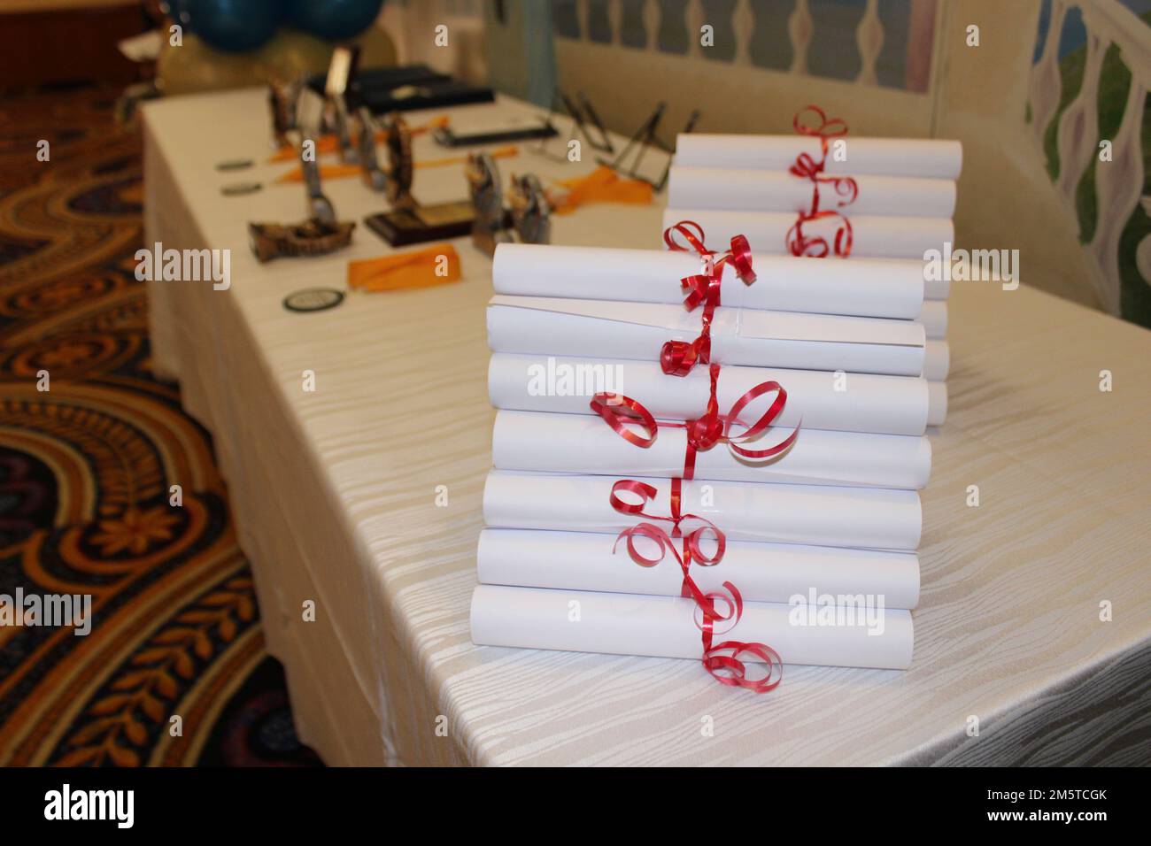 Diplomas rolled up neatly on a table Stock Photo