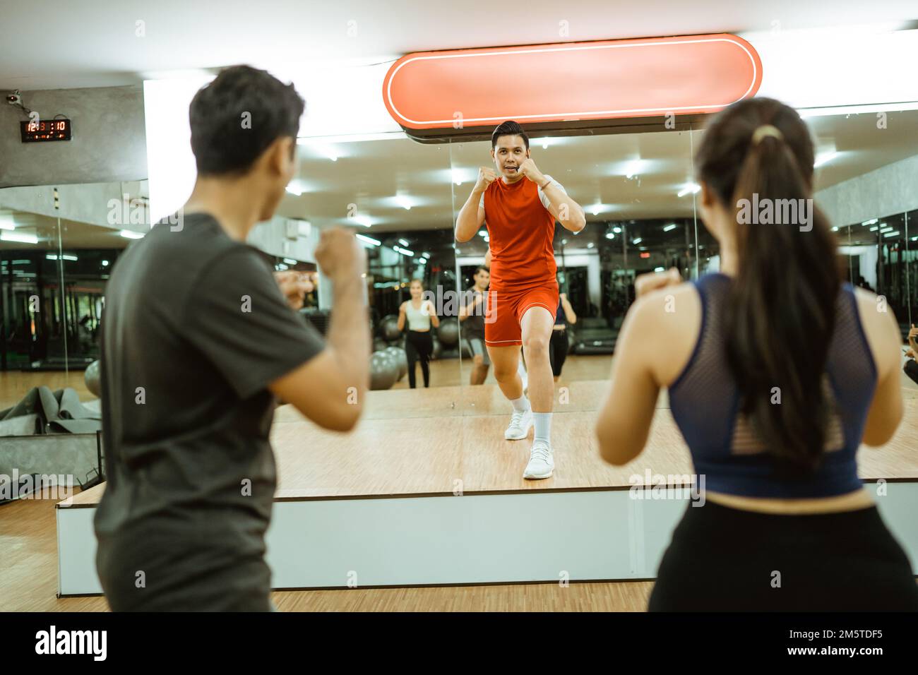instructor on stage doing the hold stance during group exercises Stock ...