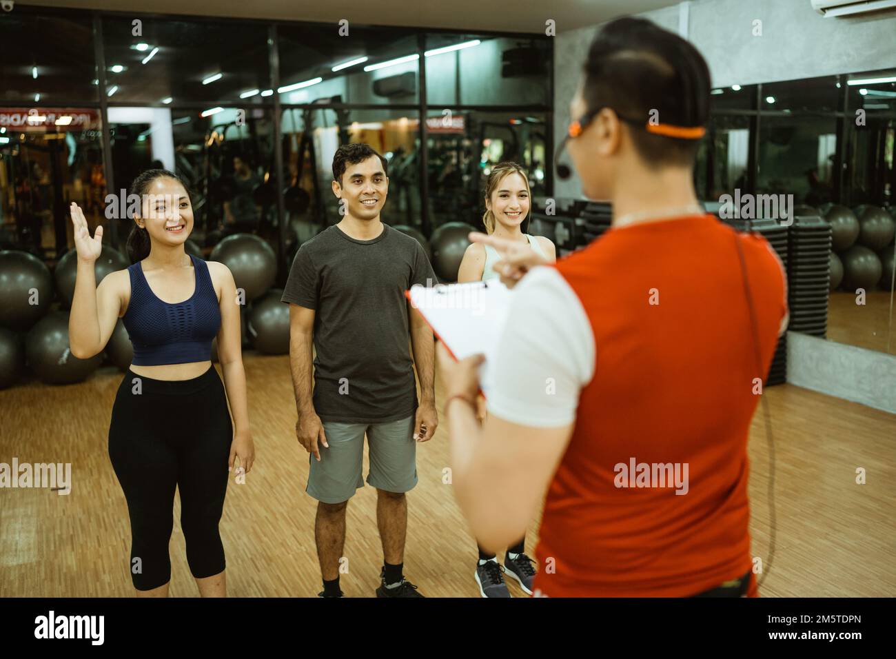 Asian male instructor leading three members for group briefing Stock Photo