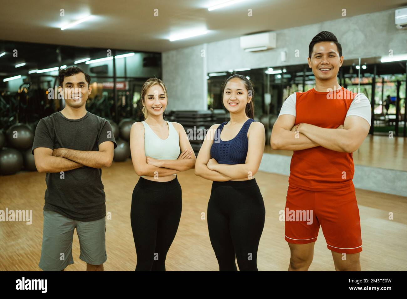 Group of diverse young friends in gym after exercise Stock Photo