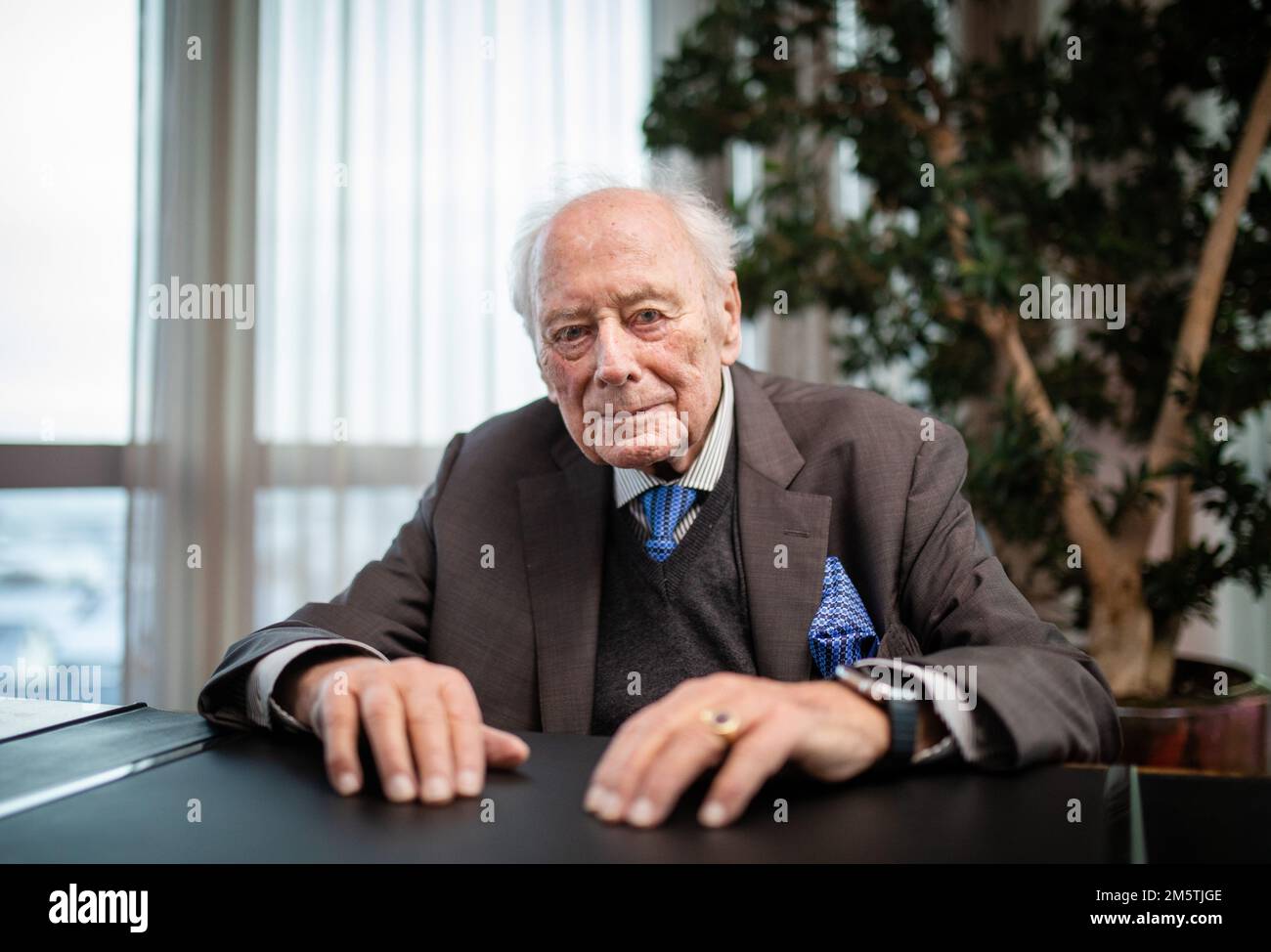 PRODUCTION - 13 December 2022, Baden-Wuerttemberg, Künzelsau: Reinhold Würth, Chairman of the Advisory Board of the Würth Group, sits at his desk at the company headquarters in Künzelsau. In order to secure the success of his company in the long term, entrepreneur Reinhold Würth wants to see more computer scientists at the Würth Group. (to dpa 'Reinhold Würth: Group's success will depend on computer scientists') Photo: Christoph Schmidt/dpa Stock Photo