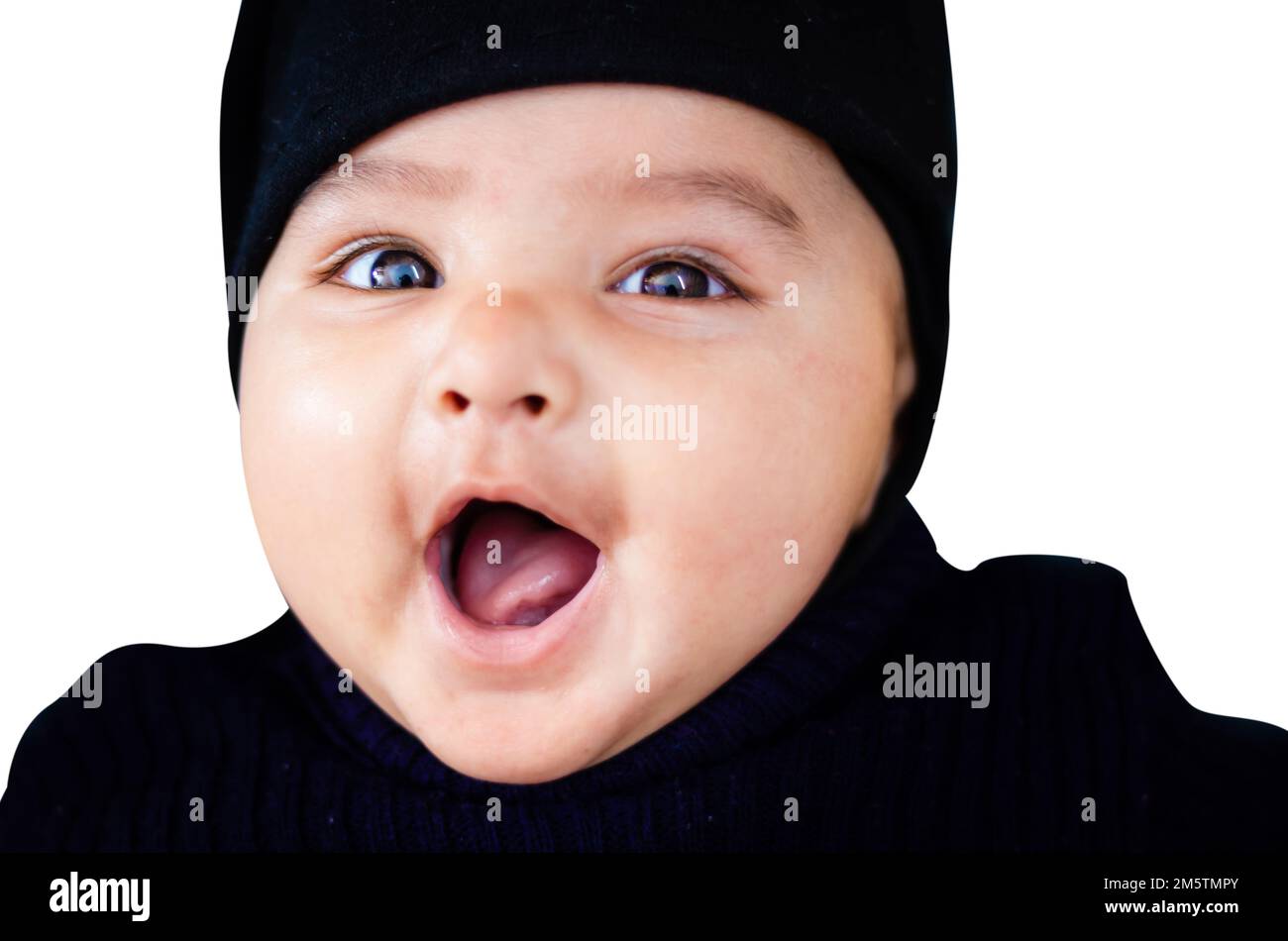 infant boy in black outfit lying cute facial expression at indoor from