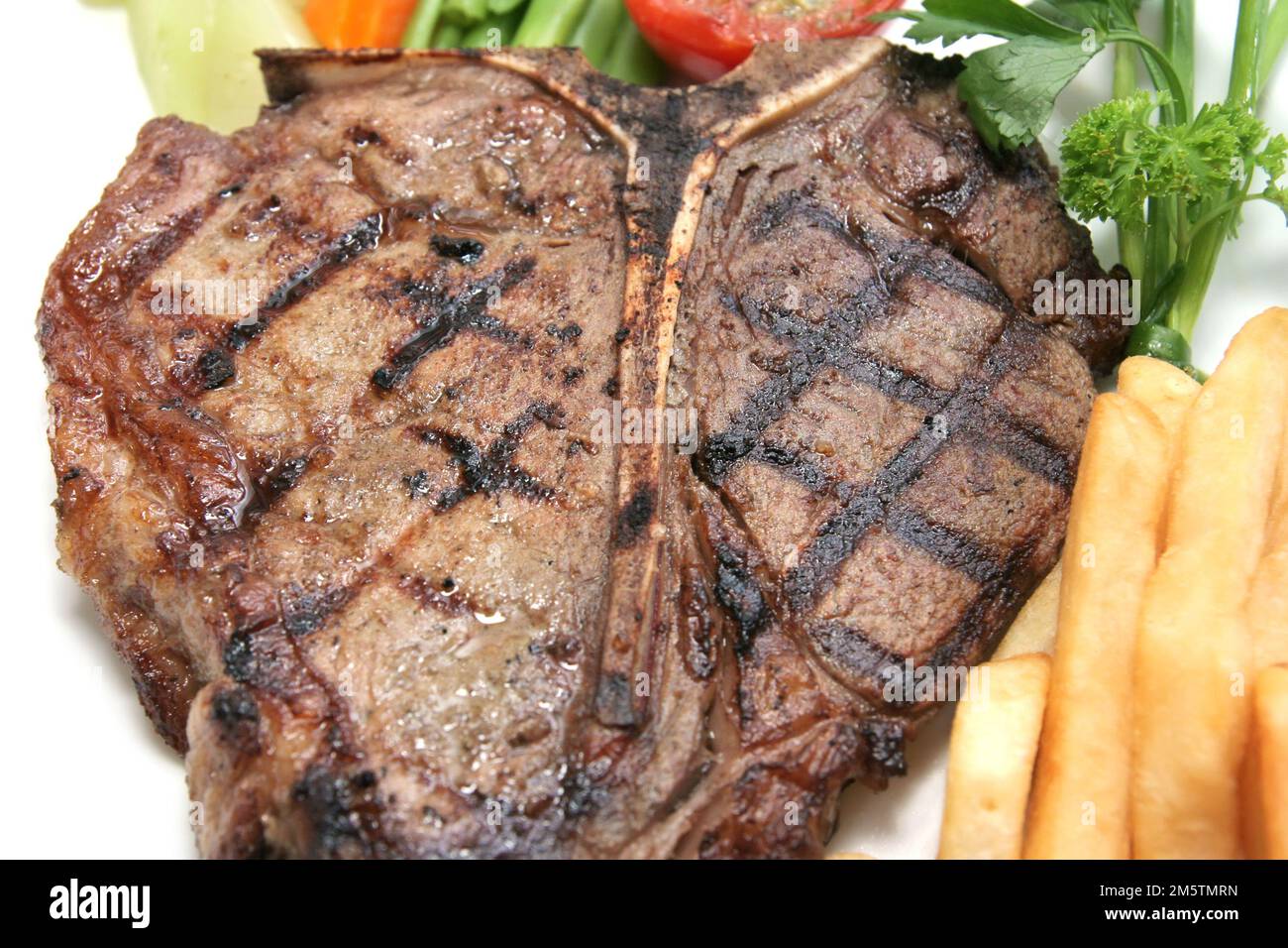 delicious grilled Tbone steak barbecue portion with frenchfries on