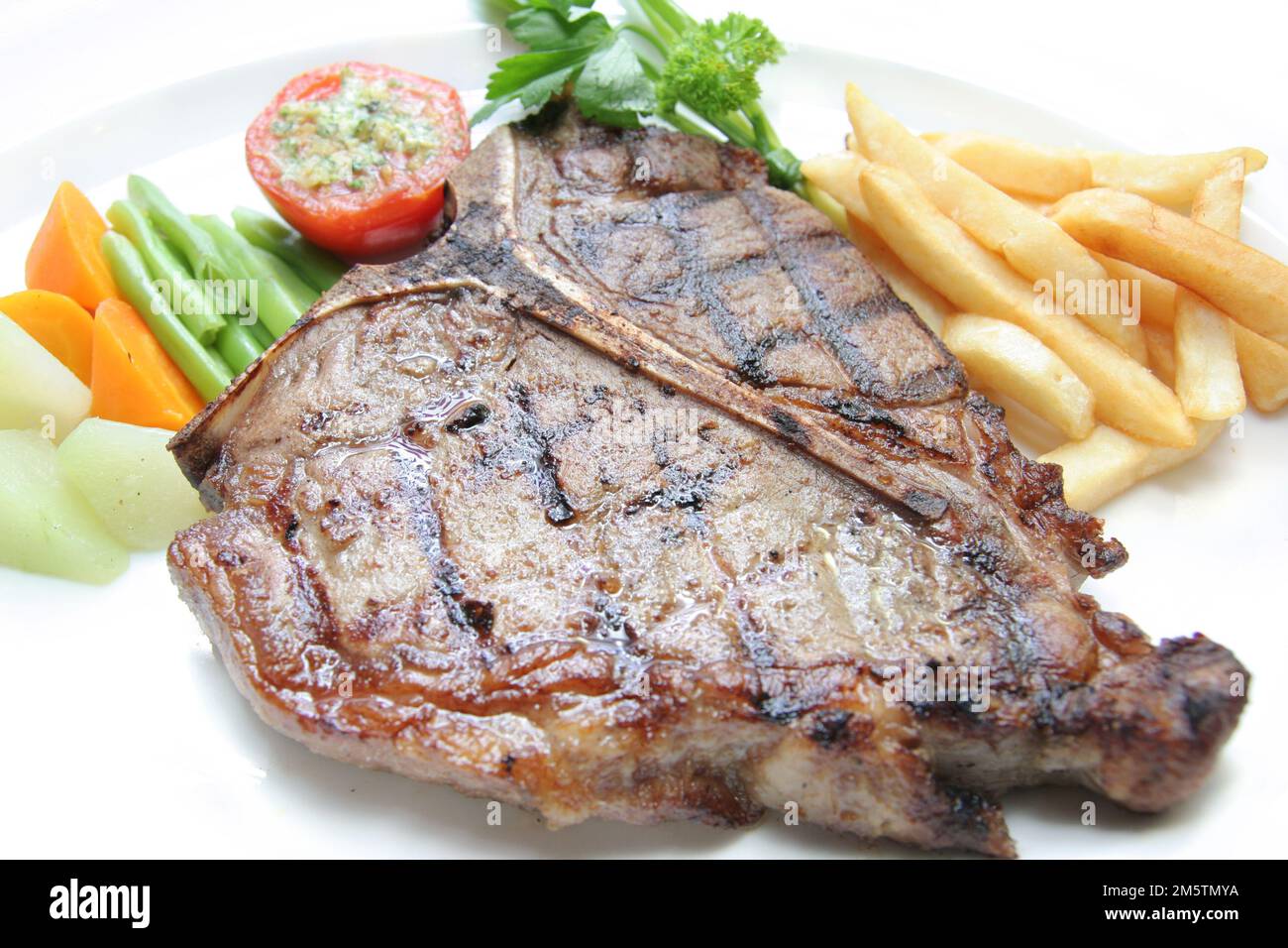 delicious grilled Tbone steak barbecue portion with frenchfries on