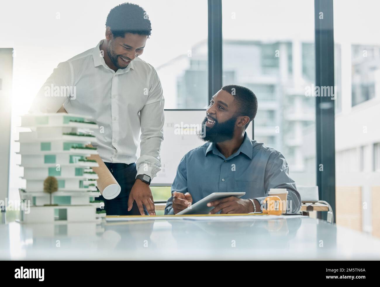 Tablet, architecture and collaboration with a business black man architect team working in their office. Building, design or teamwork with a male Stock Photo