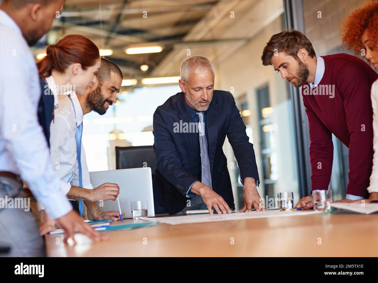 Getting down to business. a group of businesspeople discussing documents in a meeting. Stock Photo
