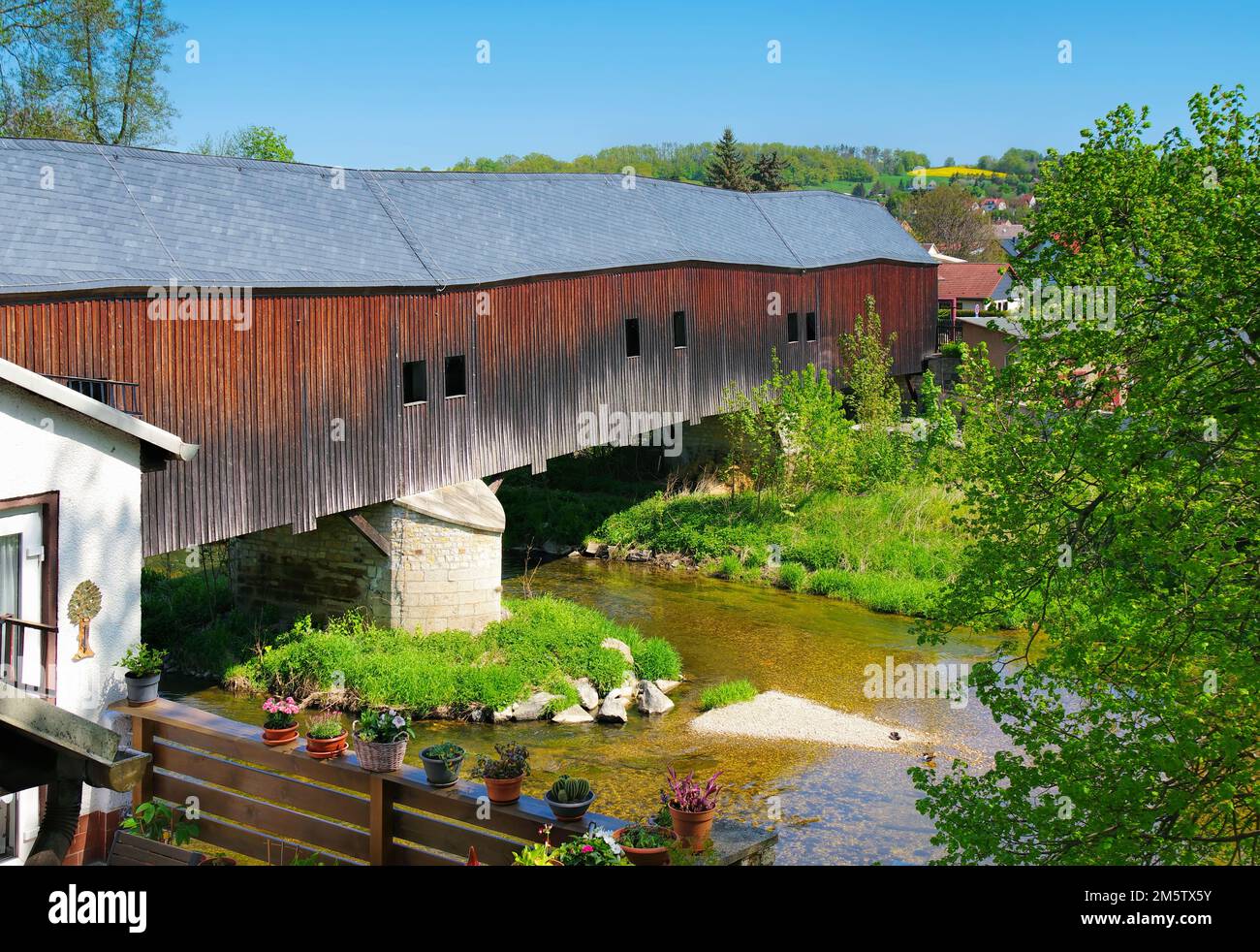 Wuenschendorf in the Vogtland over the Elster river, historic covered wooden bridge Stock Photo