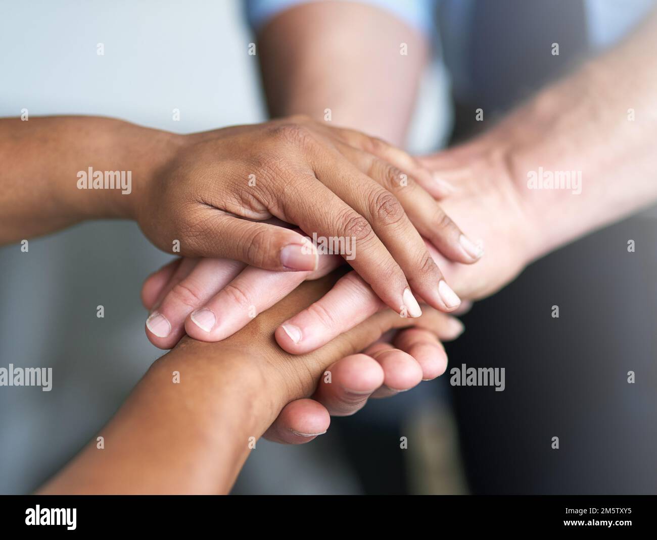 Its all about teamwork two peoples hands together in unity stock photo