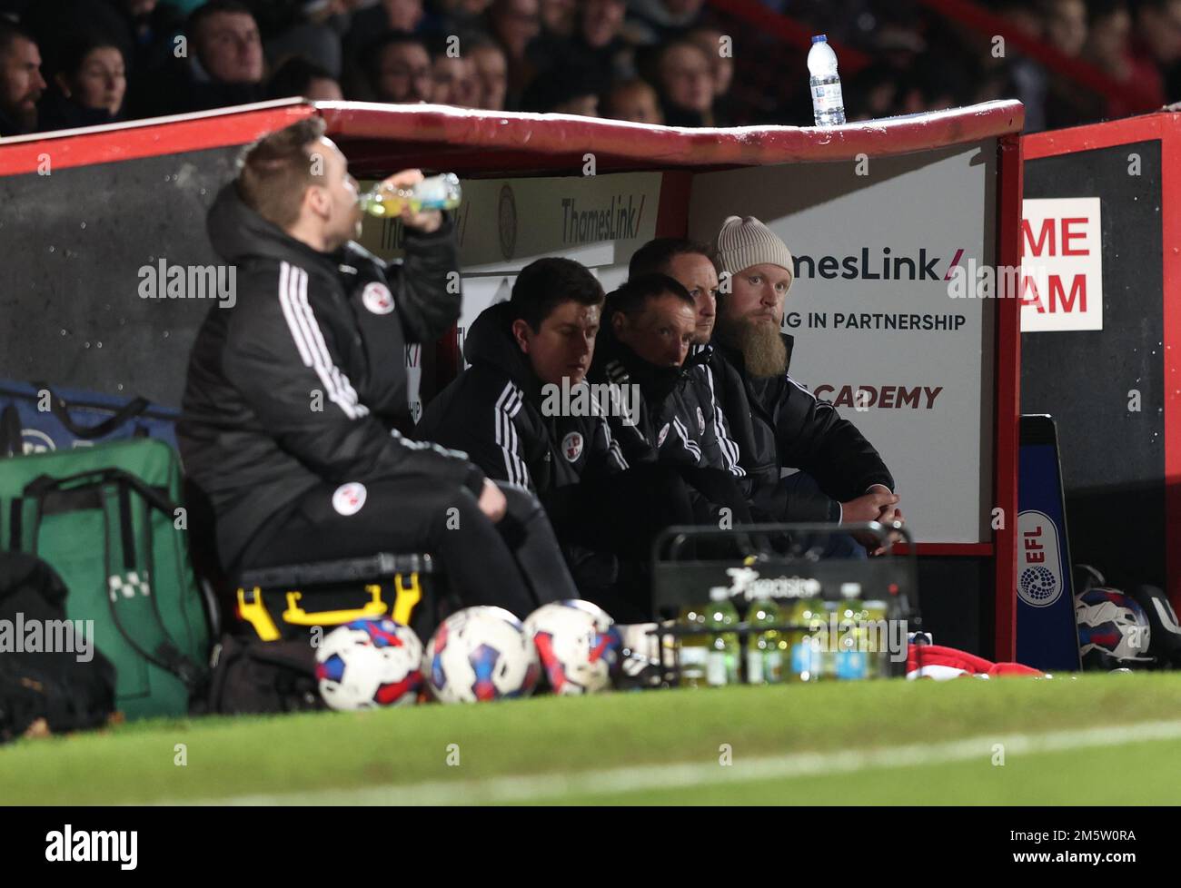 Crawley Town FC Co Owner Preston Johnson (R) sitting in the dug-out during the EFL League Two match between Stevenage v Crawley Town at the Lamex Stadium. 30th Dec 2022 Stock Photo