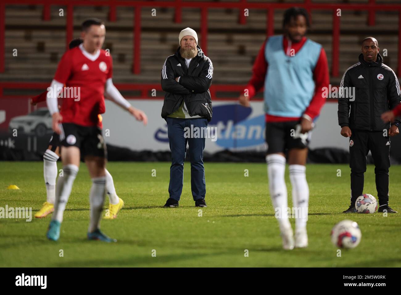 Crawley Town Co Owner Preston Johnson (2nd L) and interim manager Darren Byfield  watch the warm-up before the EFL League Two match between Stevenage v Crawley Town at the Lamex Stadium. 30th Dec 2022 Stock Photo