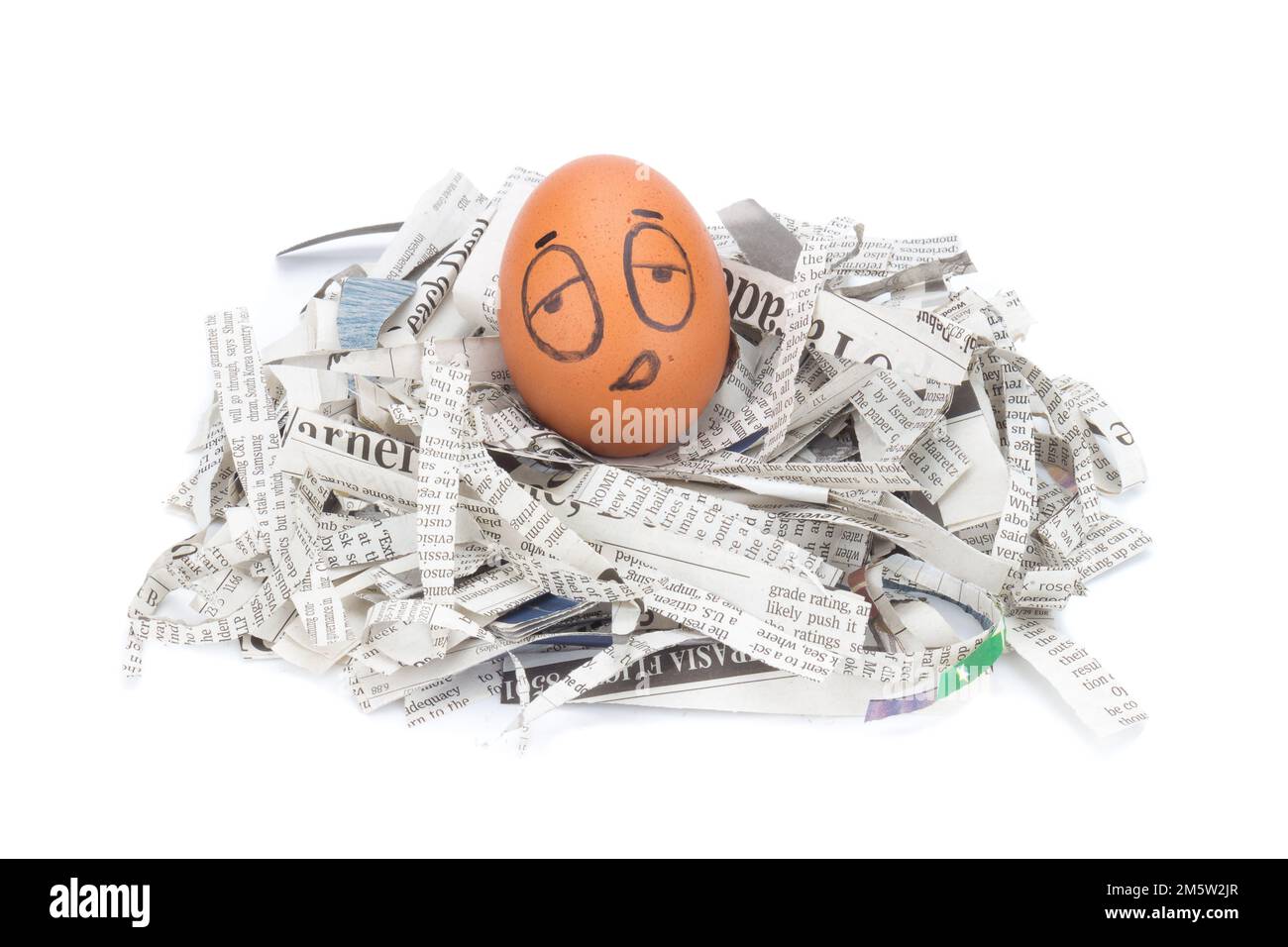egg face sleepy on newspapers recycle. Stock Photo