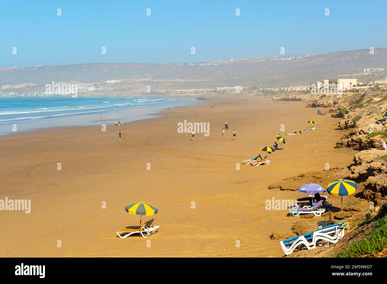 Sandy beach view towards Taghazout, Morocco, North Africa Stock Photo