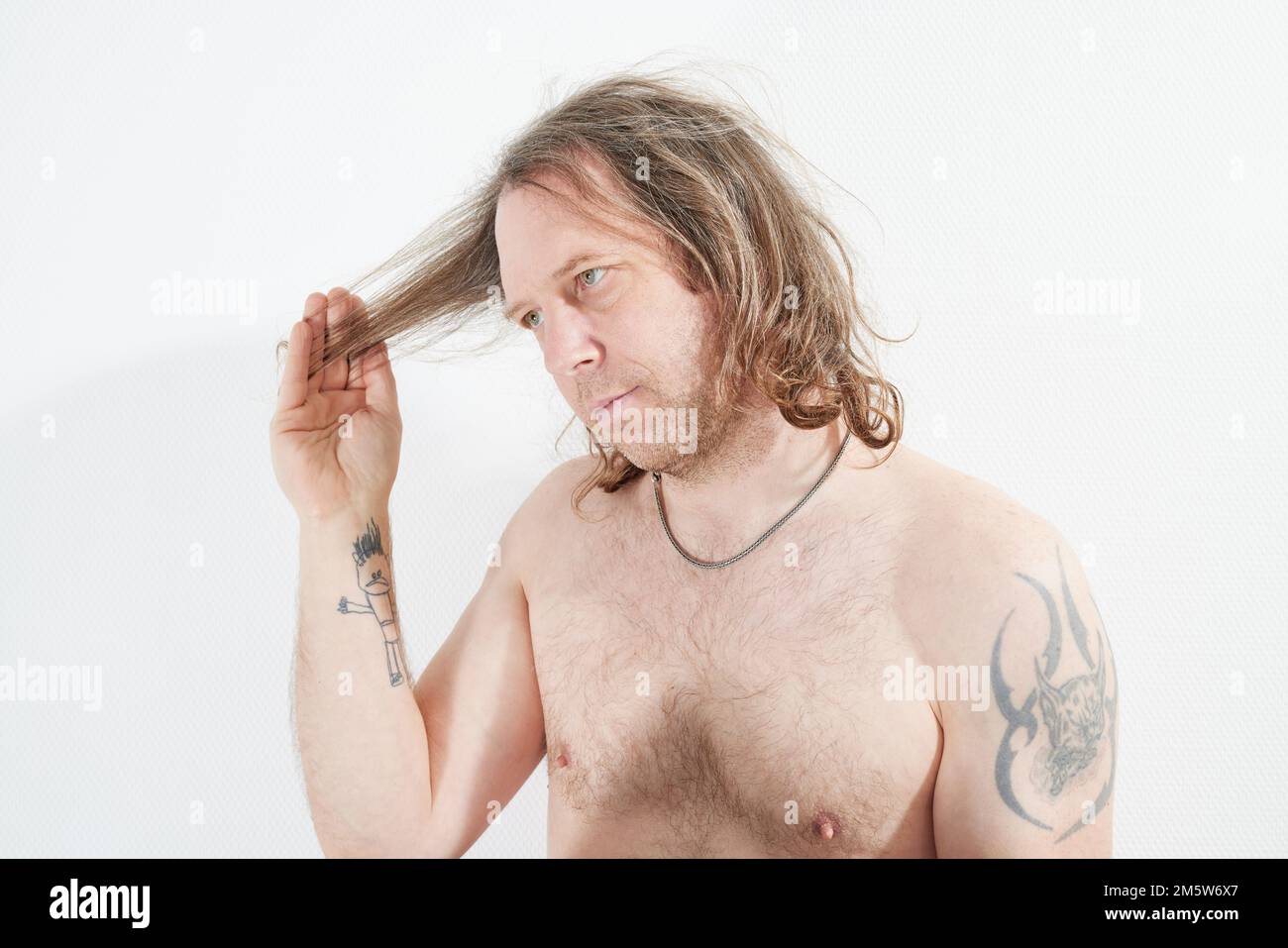 Man with hand on his long hair Stock Photo