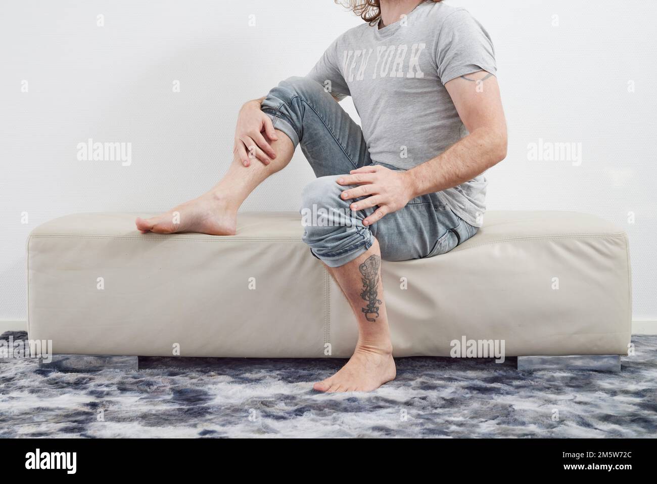 Man sitting barefoot hi-res stock photography and images - Alamy