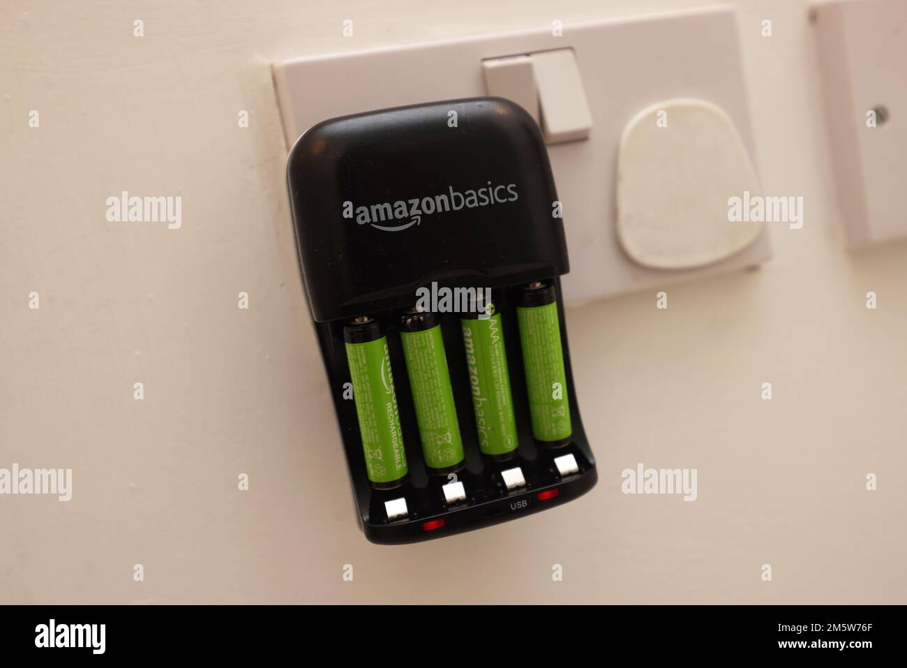 An Amazon Basics Rechargeable Batteries Plug charging up some AAA
