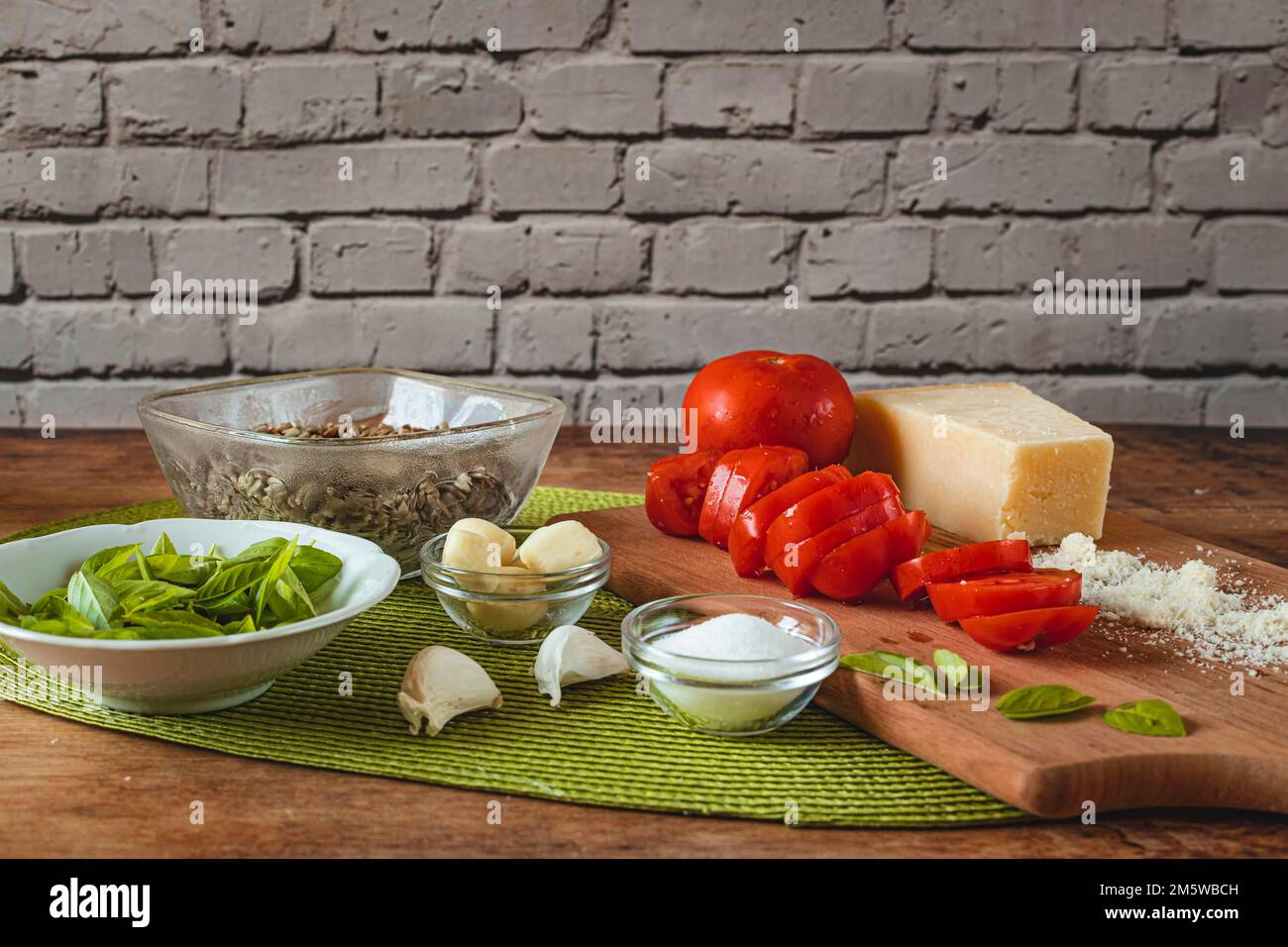 Food photography, making tomato pesto, with tomatoes (Solanum lycopersicum), salt, sunflower (Helianthus annuus) seeds, sunflower oil, basil (Ocimum Stock Photo