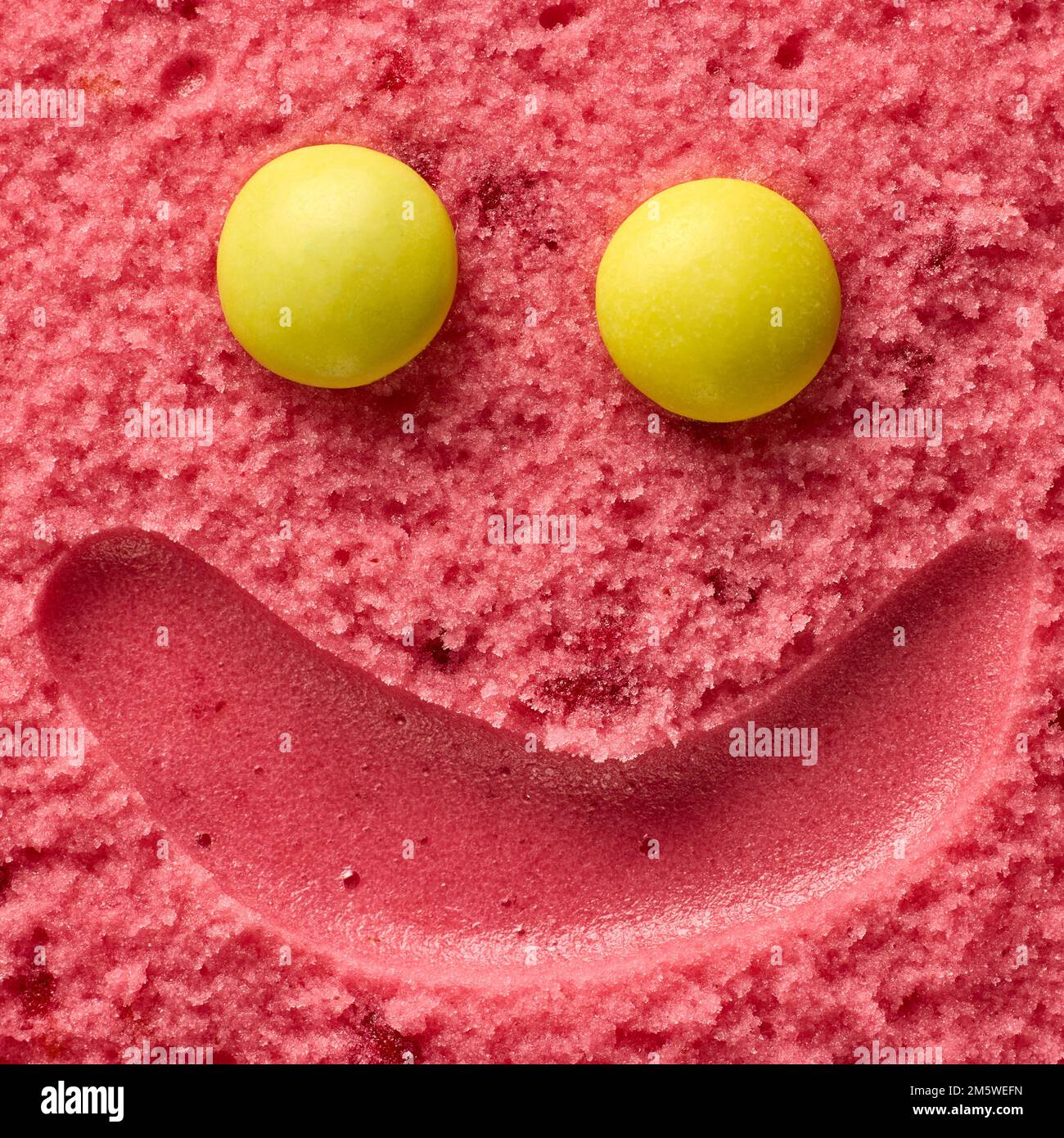 funny smiling ice cream face, raspberry sorbet and yellow round candies ...
