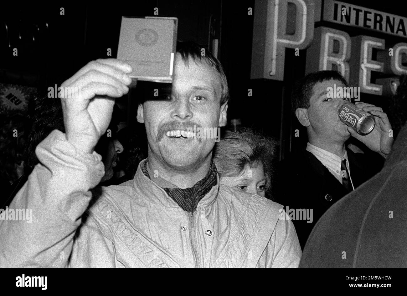 GDR, Berlin, 09. 11. 1989, Opening of the Berlin Wall, Celebration on KuDamm (Kurfuerstendamm), GDR citizen shows his GDR identity card Stock Photo