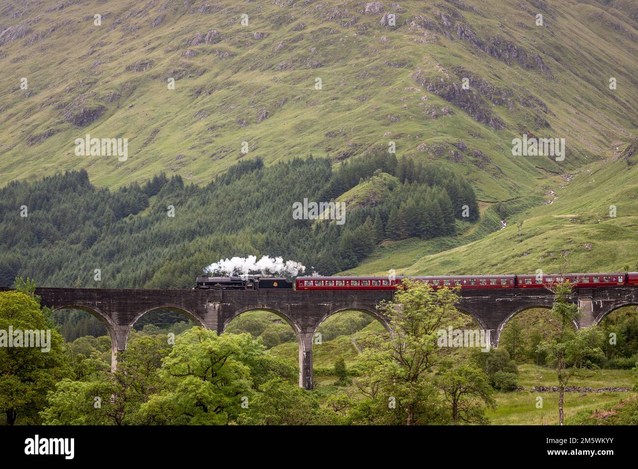 BR 4-6-0 '5MT' No. 45407 crosses the Glenfinnan Viaduct, Highlands, Scotland, UK Stock Photo