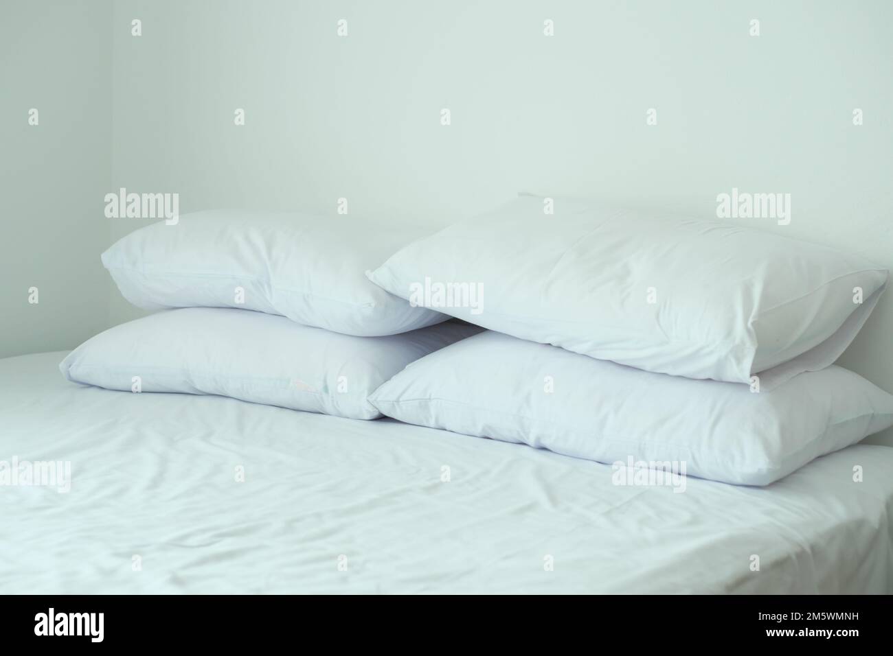 white pillow lined up on bed Stock Photo