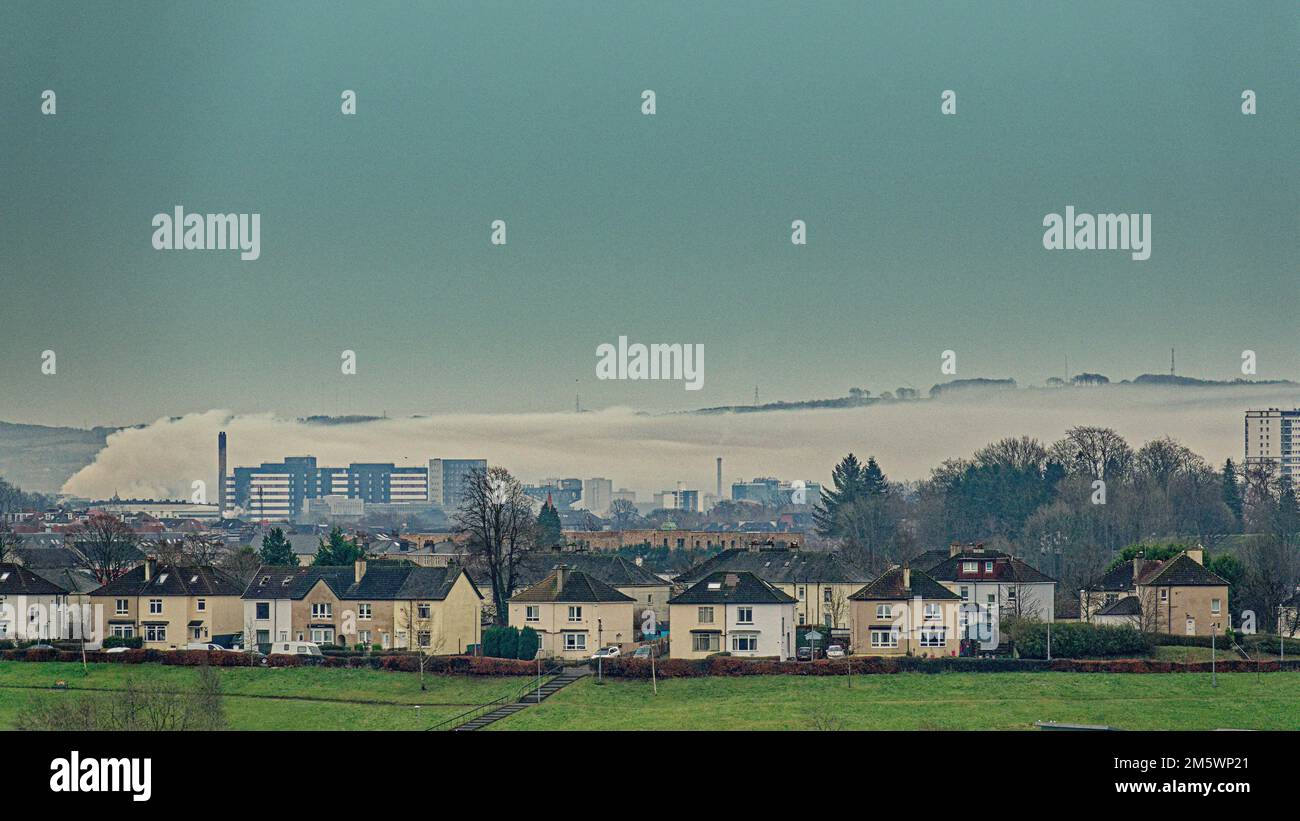 Glasgow, Scotland, UK 31st December, 2022. UK Weather:  Huge fire in Rutherglen covered the city in smoke  from water hoses causing create a large low lying cloud over the south east of the city pictured from 7 miles away. Credit Gerard Ferry/Alamy Live News Stock Photo