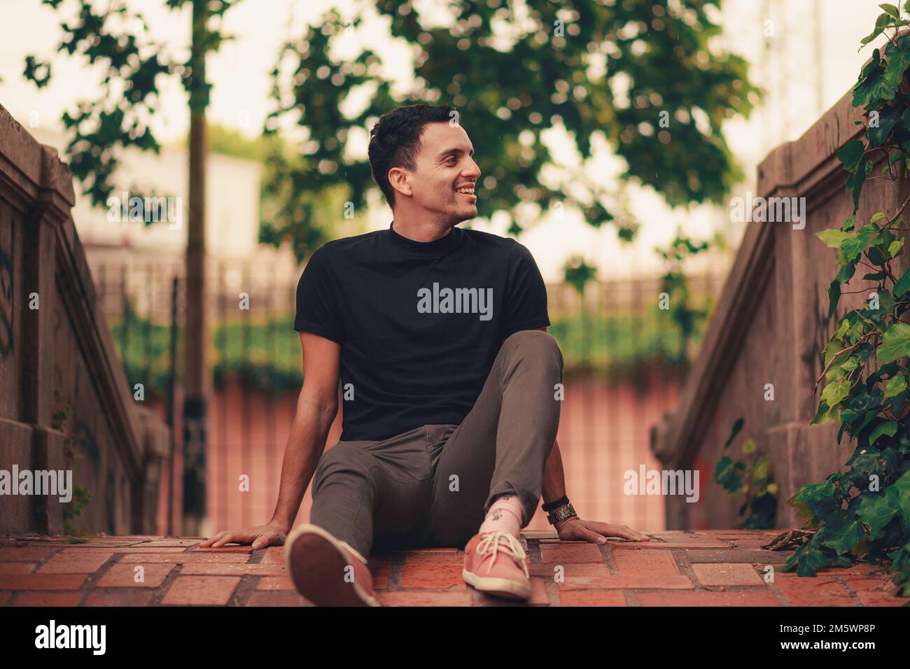A handsome Hispanic young man posing in the park. Stock Photo