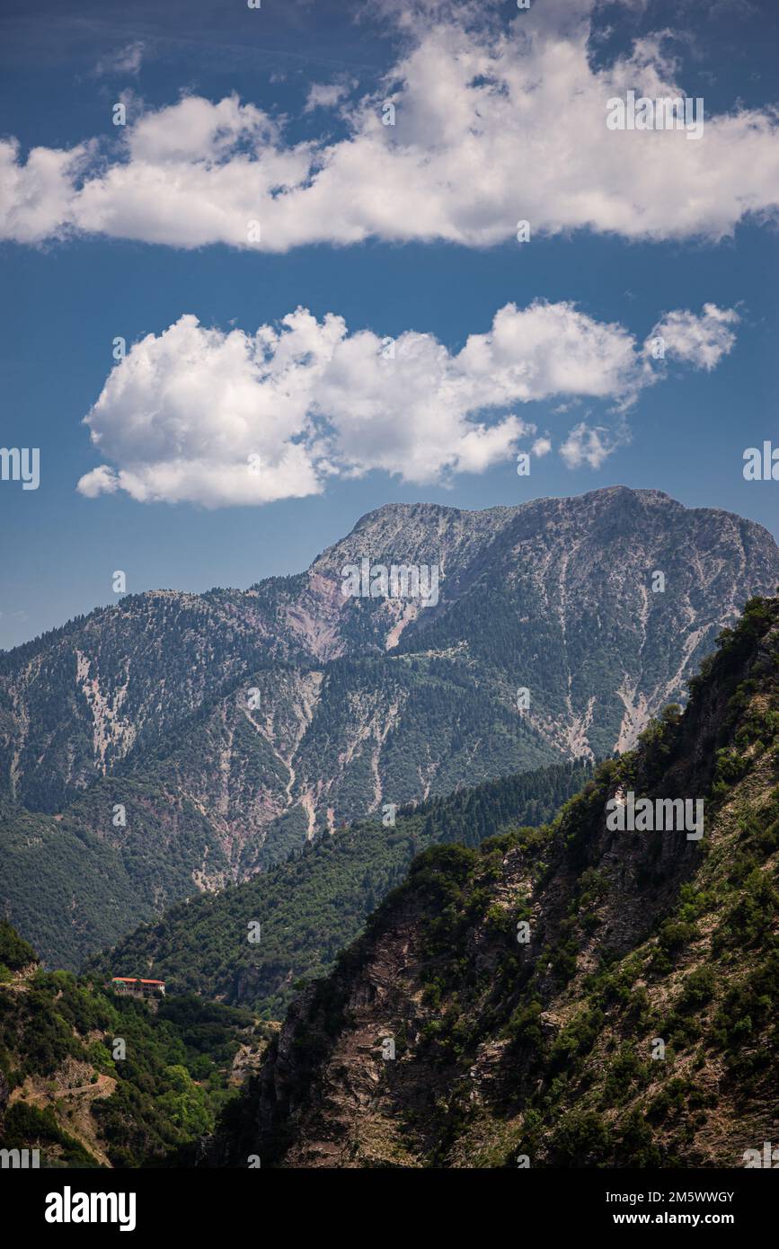 A vertical image of green covered mountains with beautiful sky during ...