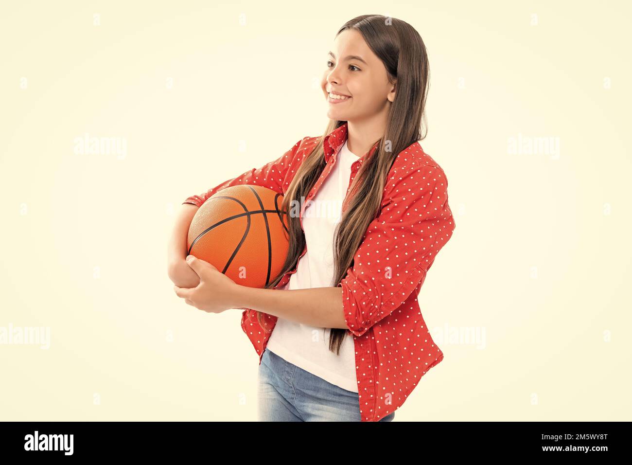 Teen girl with basketball ball isolated on white background. Portrait