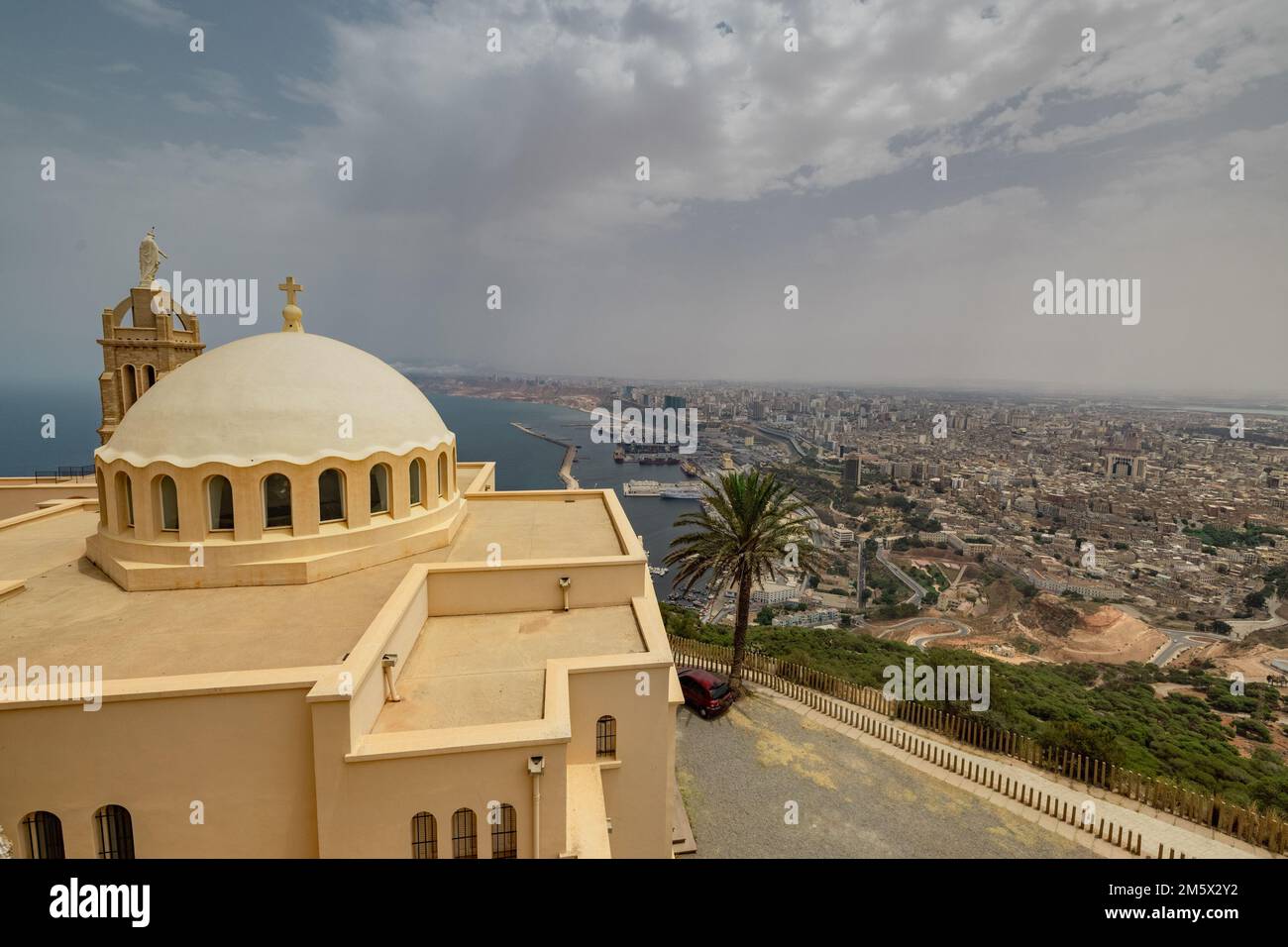 Panorama view of blessed virgin mary church from Santa Cruz fortress, one of the three forts in Oran, the second largest port of Algeria; Summer day, Stock Photo