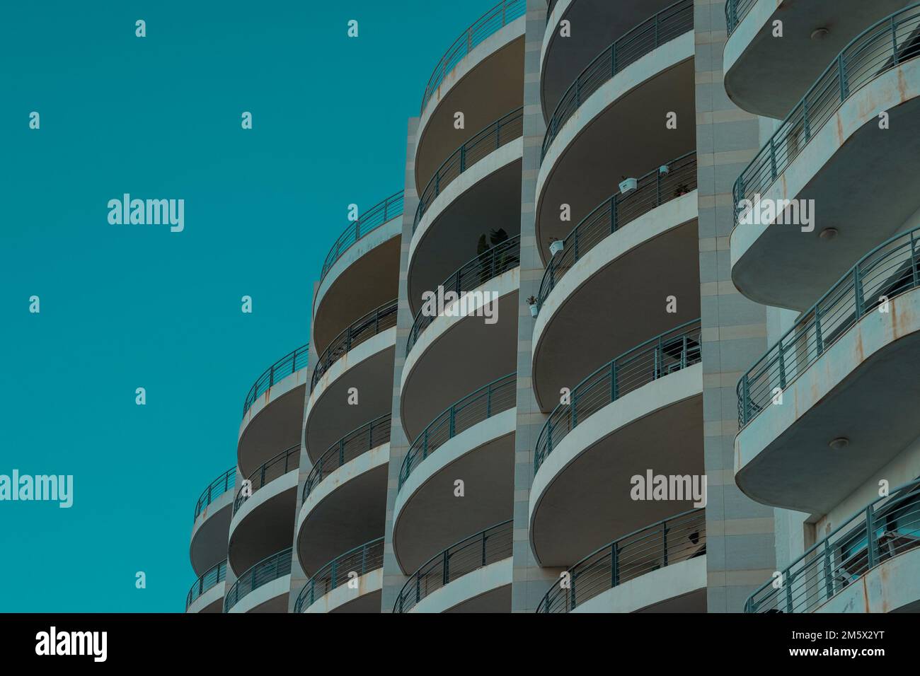 Interesting arhitectural round elements of building or hotel. Multiple balconies forming an interesting view. Stock Photo