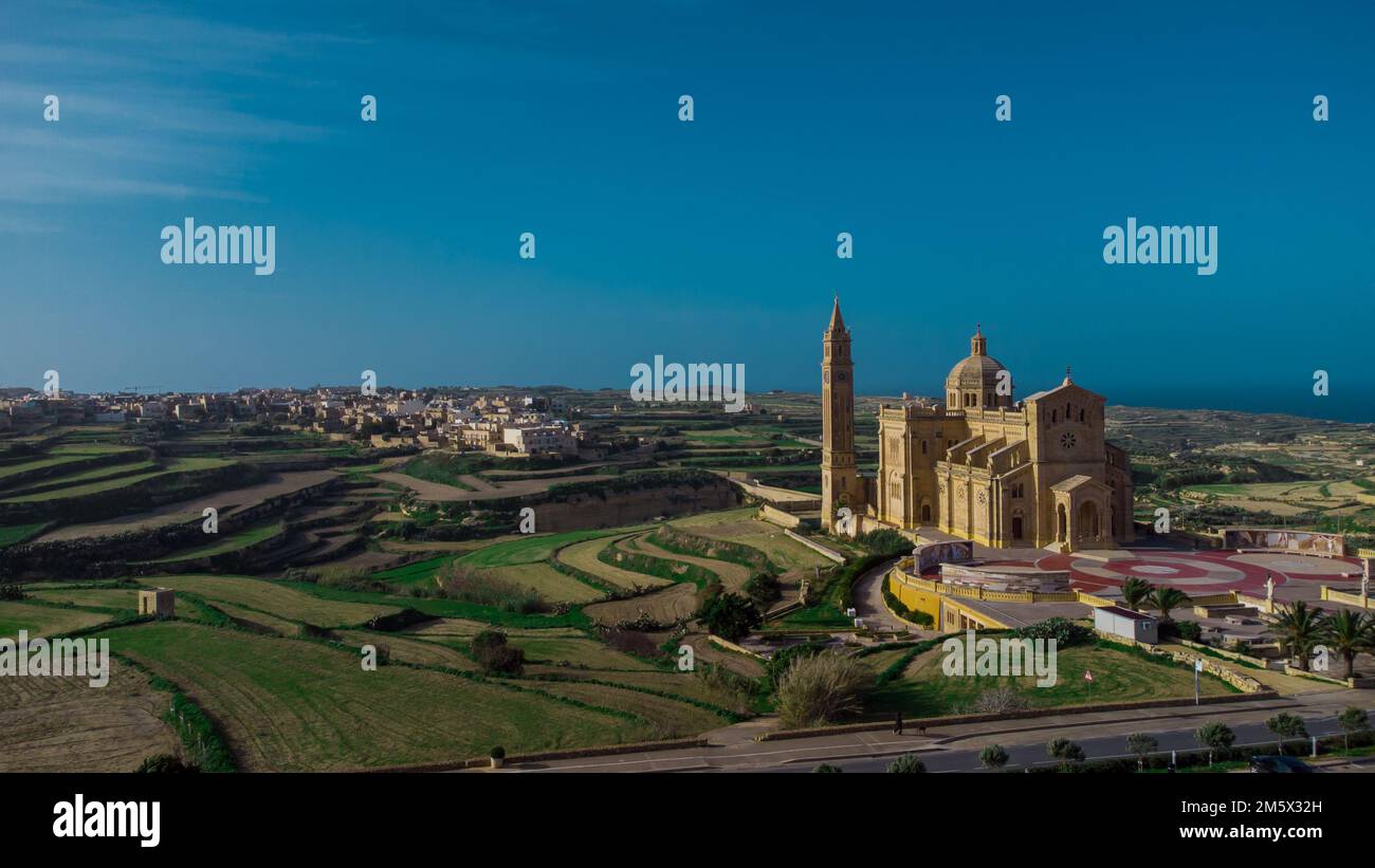 Drone panorama or majestic and big Basilica of the National Shrine of the Blessed Virgin of Ta' Pinu on the island of Gozo, Malta on a sunny day. Stock Photo