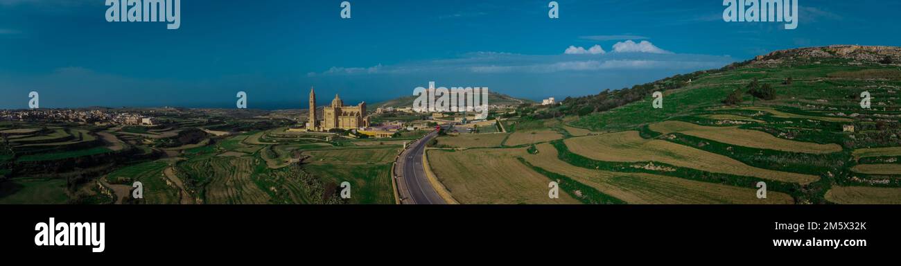 Wide Drone panorama or majestic and big Basilica of the National Shrine of the Blessed Virgin of Ta' Pinu on the island of Gozo, Malta on a sunny day. Stock Photo