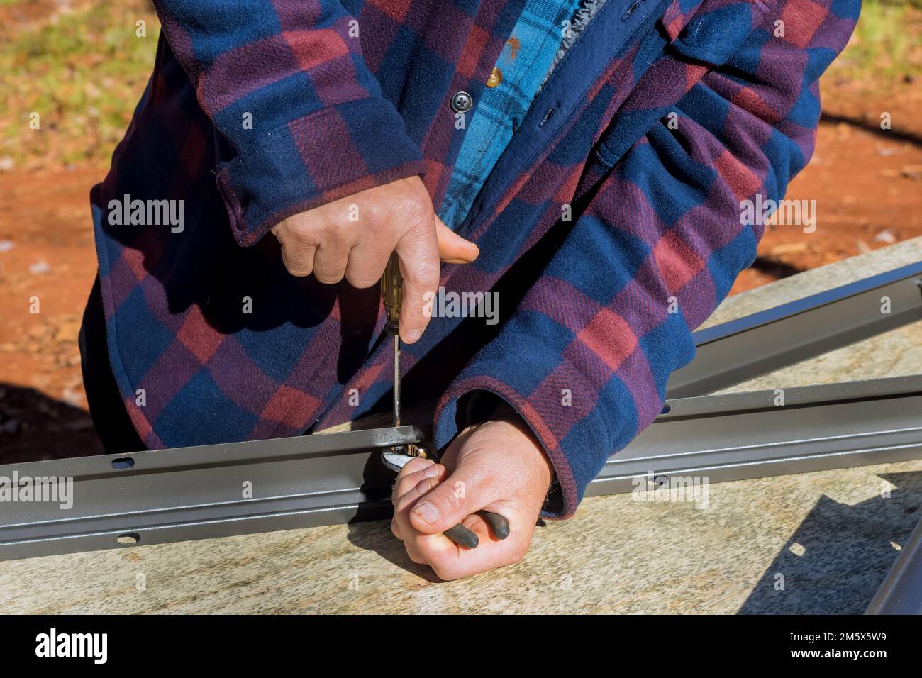 Putting together assembling plastic shed for backyard Stock Photo Alamy
