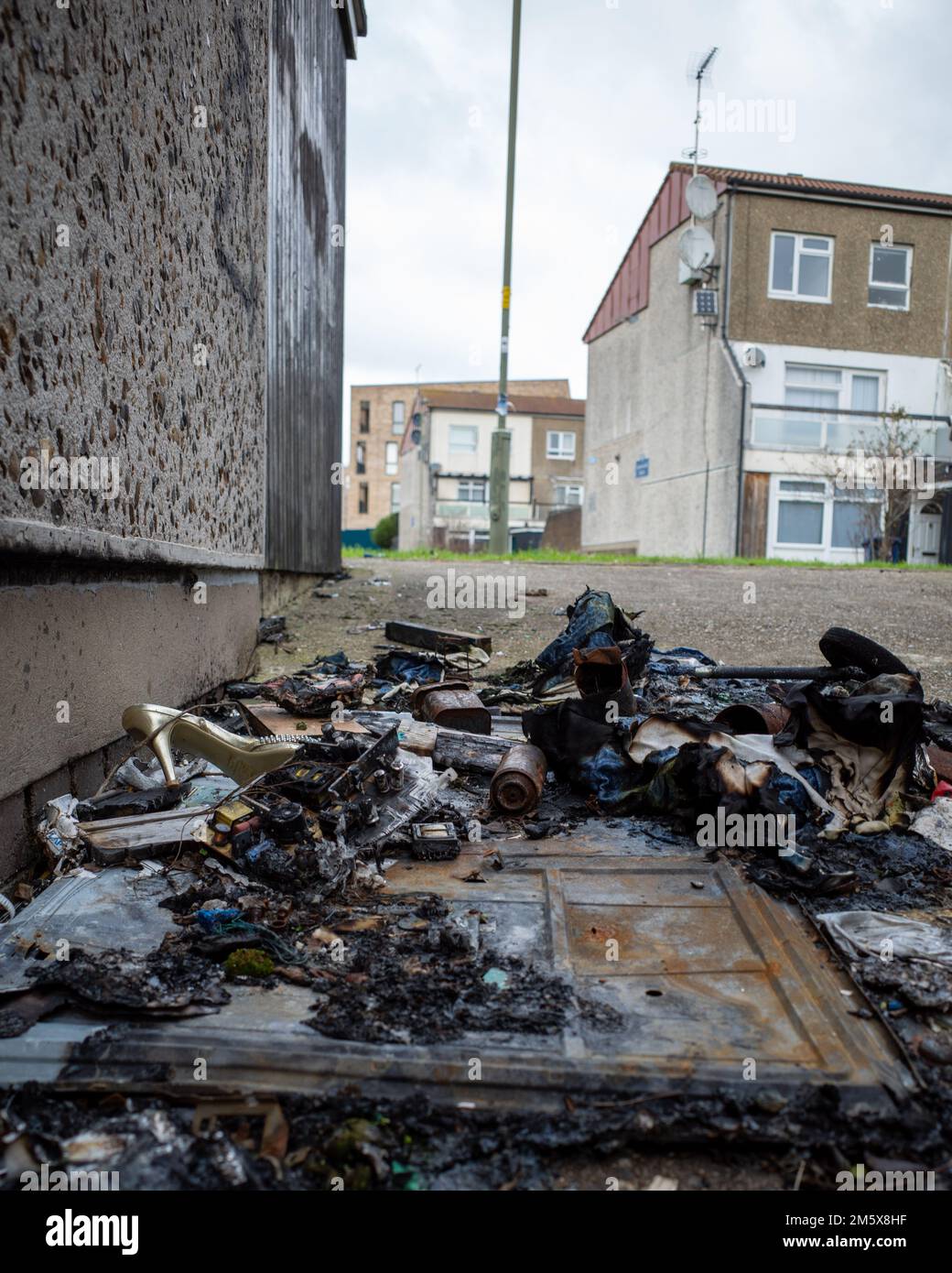 Burnt out rubbish in run down housing estate, North London. Dollis