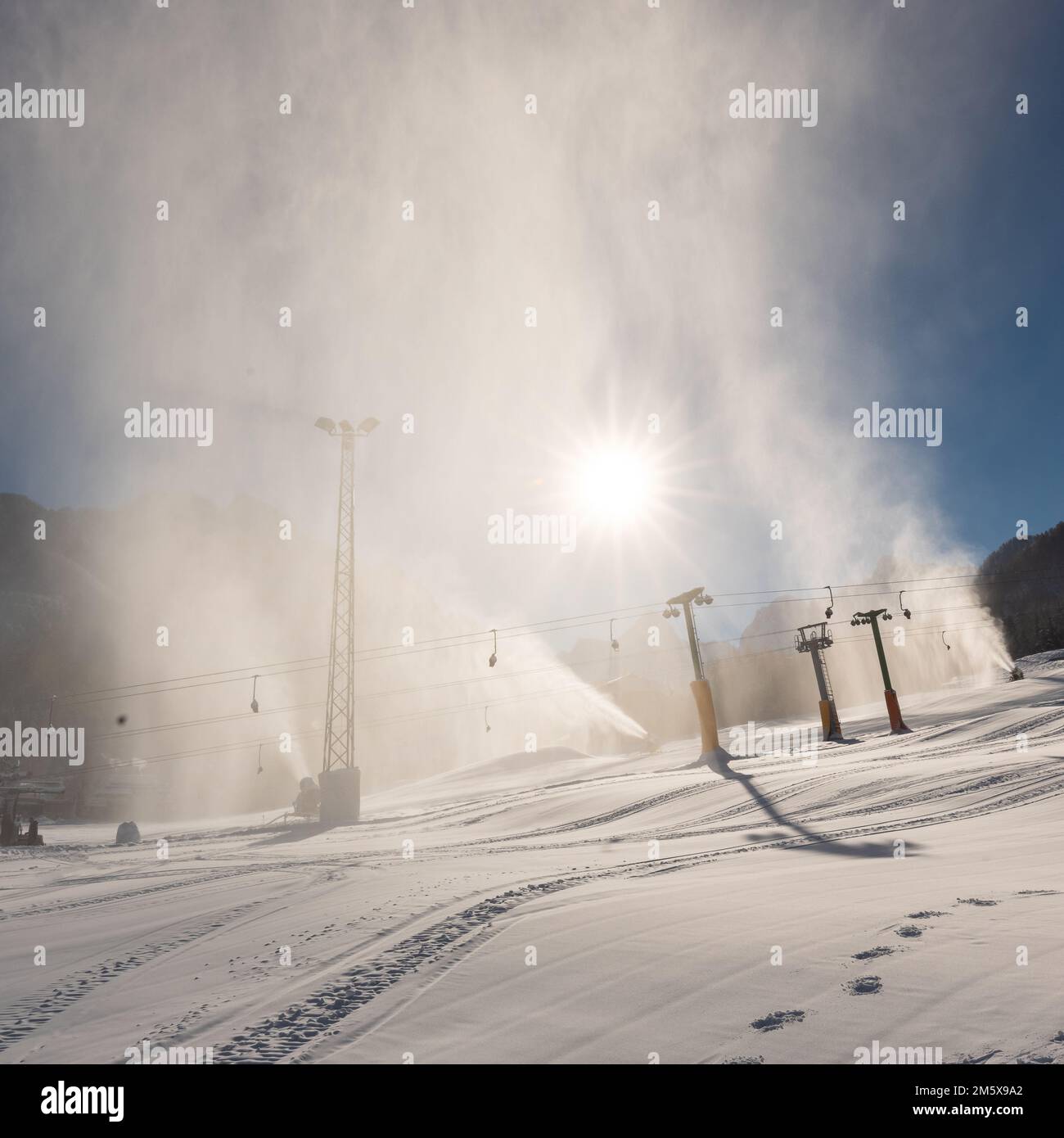 Snowmaking machine snow cannon or gun in action on a cold sunny winter day in ski resort Kranjska Gora, Slovenia Stock Photo