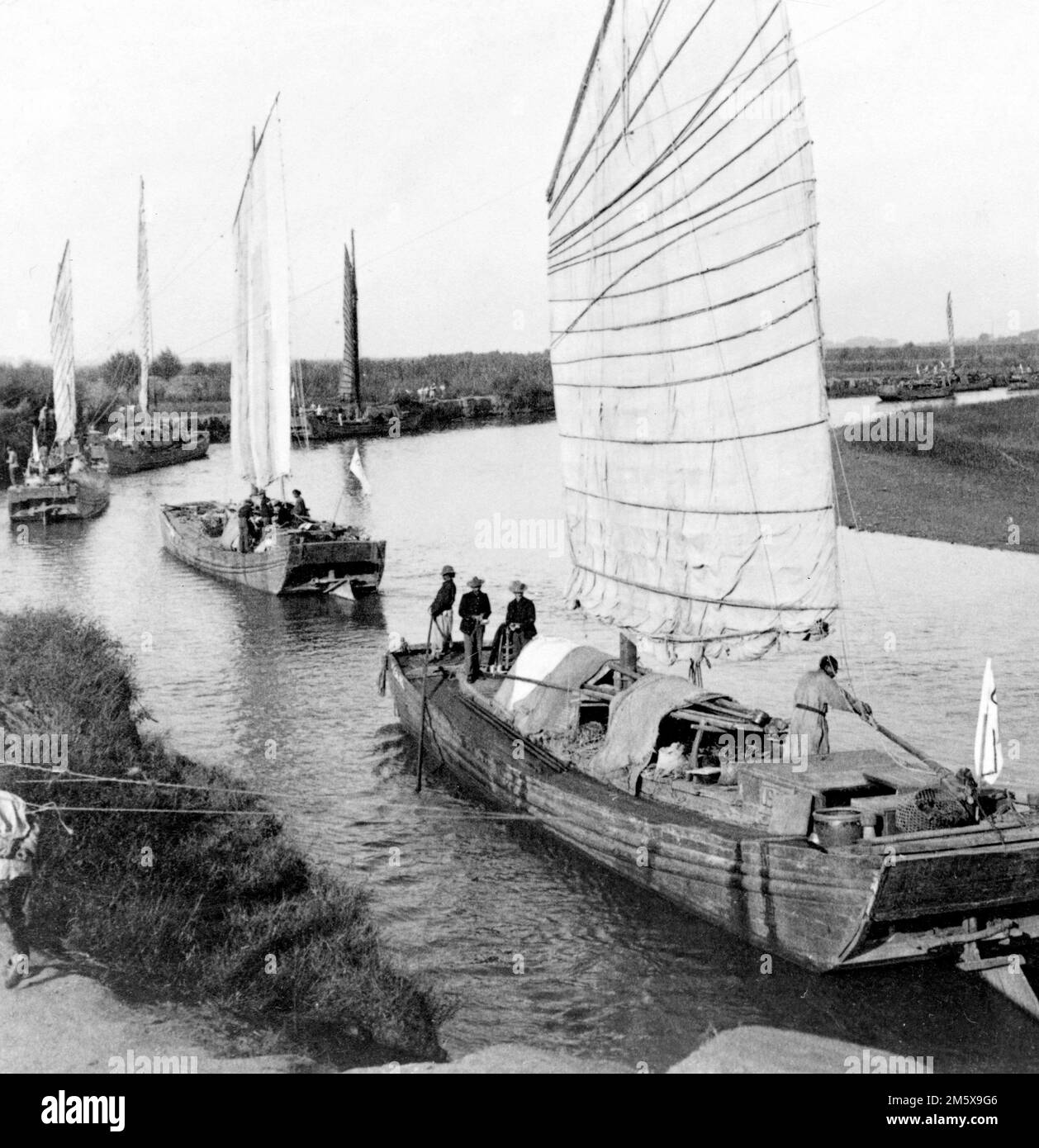 Boxer Rebellion. Junk flotilla on the Peiho River - transporting U.S. Army stores from Tientsin to Peking, China. Photo by Underwood and Underwood, 1900 Stock Photo
