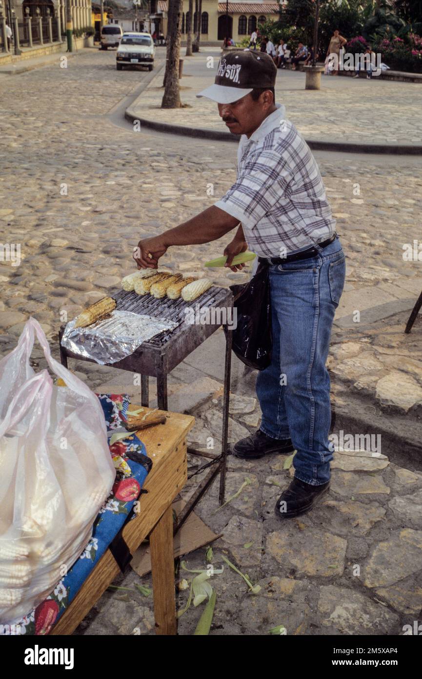 Honduras, Copan.  Street Corner Vendor of Roasted Corn. Stock Photo