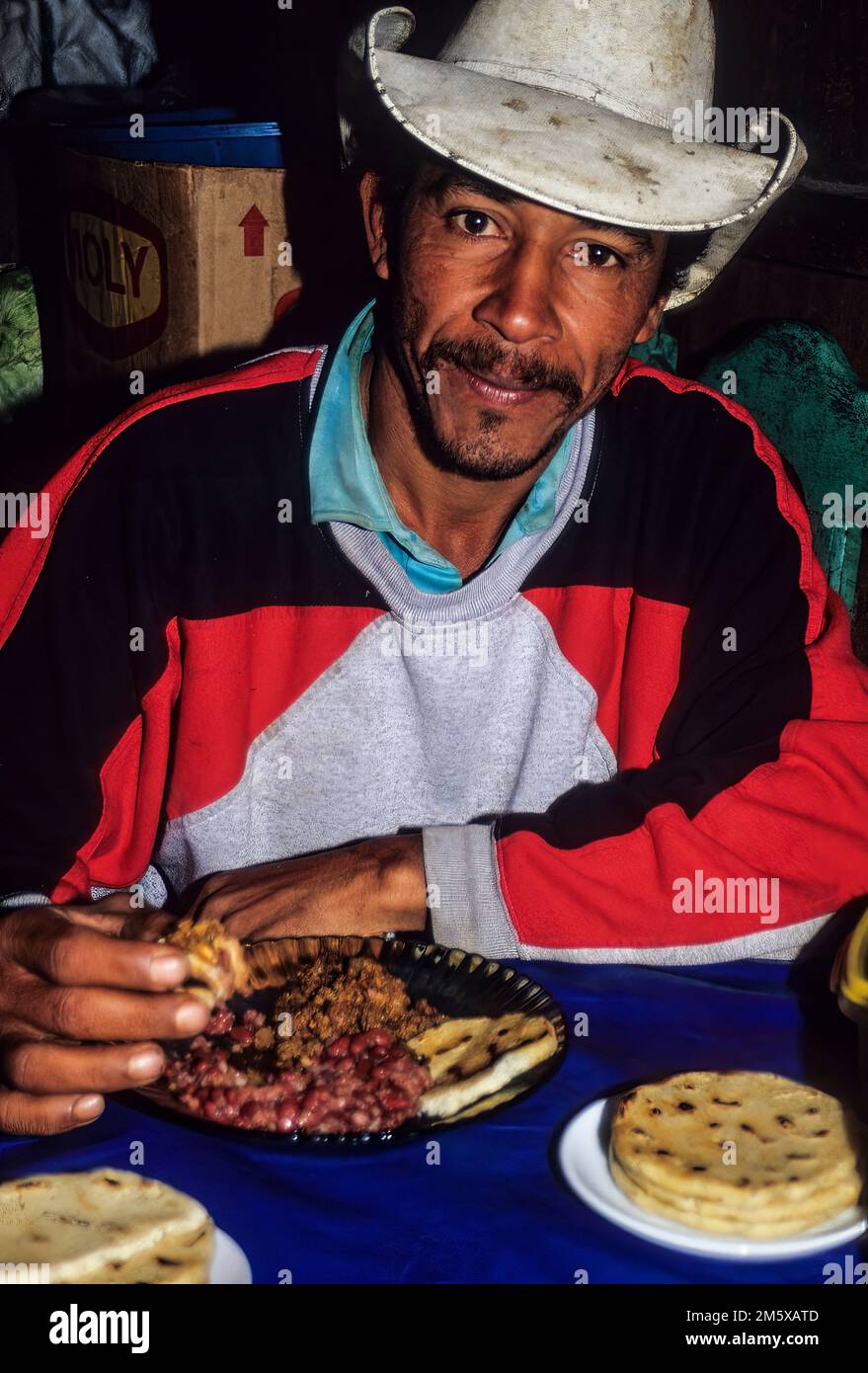 Honduras, San Luis Planes.  Man Eating Lunch of Tortillas and Beans. Stock Photo