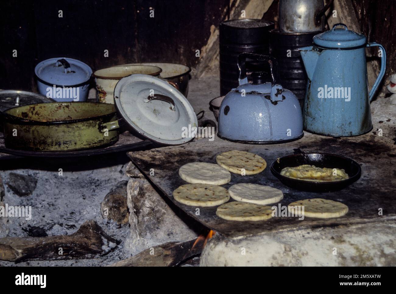 Honduras, San Luis Planes.  Cooking Tortillas over a Wood Fire in a Local Kitchen. Stock Photo