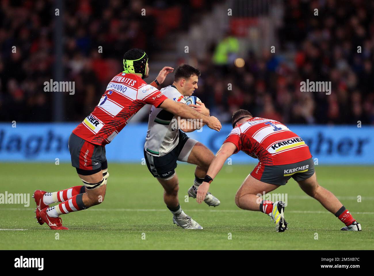 London Irish's Ben White tackled by Gloucester Rugby's Matias Alemanno and Harry Elrington during the Gallagher Premiership match at Kingsholm Stadium, Gloucester. Picture date: Saturday December 31, 2022. Stock Photo