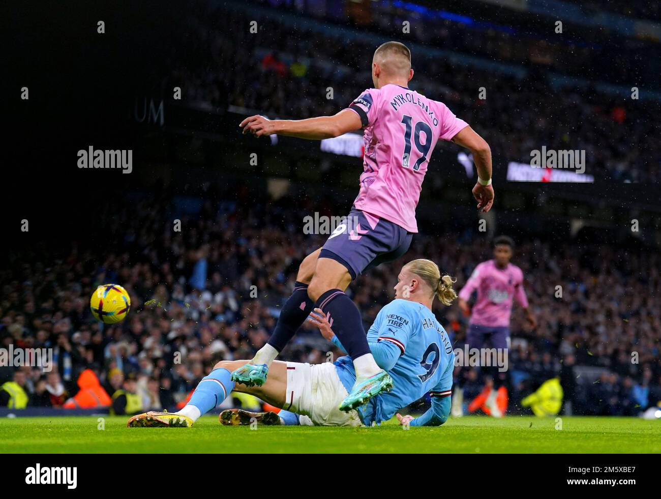 Everton's Vitaliy Mykolenko and Manchester City's Erling Haaland battle